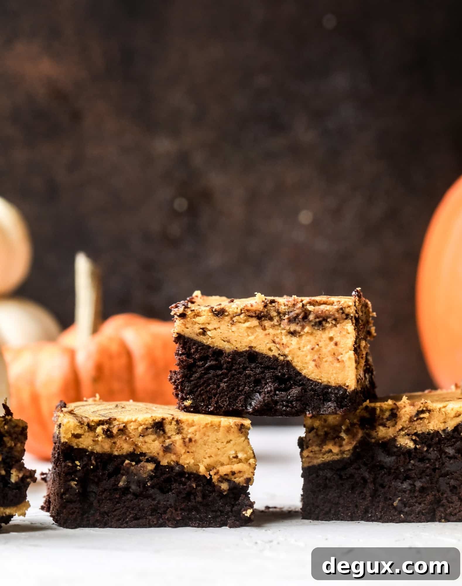 These pumpkin brownies have a fudgy layer of chocolate on the bottom and a silky layer of pumpkin on top! They are so delicious and rich and perfect for fall. The pumpkin brownies come together easily and can be made ahead of time too!