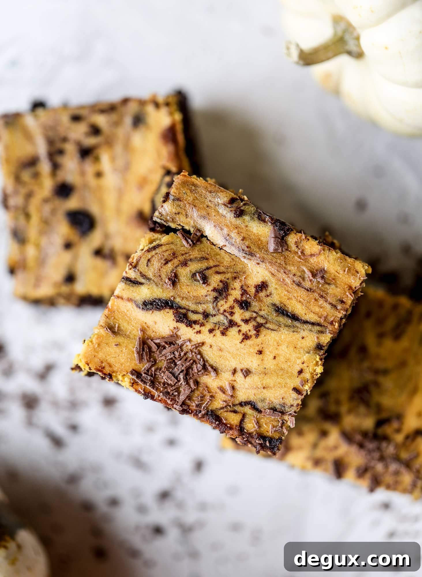 These pumpkin brownies have a fudgy layer of chocolate on the bottom and a silky layer of pumpkin on top! They are so delicious and rich and perfect for fall. The pumpkin brownies come together easily and can be made ahead of time too!