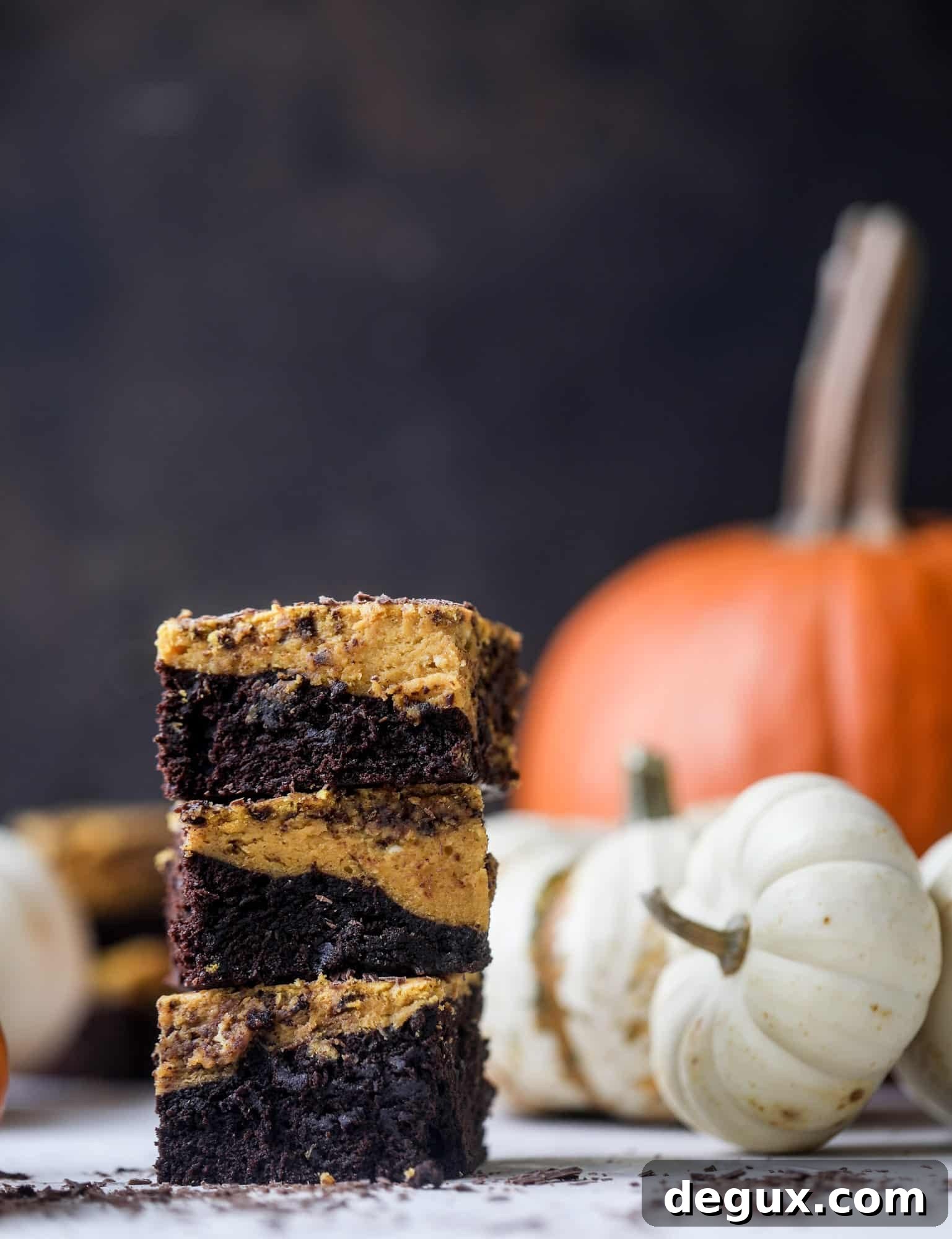 These pumpkin brownies have a fudgy layer of chocolate on the bottom and a silky layer of pumpkin on top! They are so delicious and rich and perfect for fall. The pumpkin brownies come together easily and can be made ahead of time too!