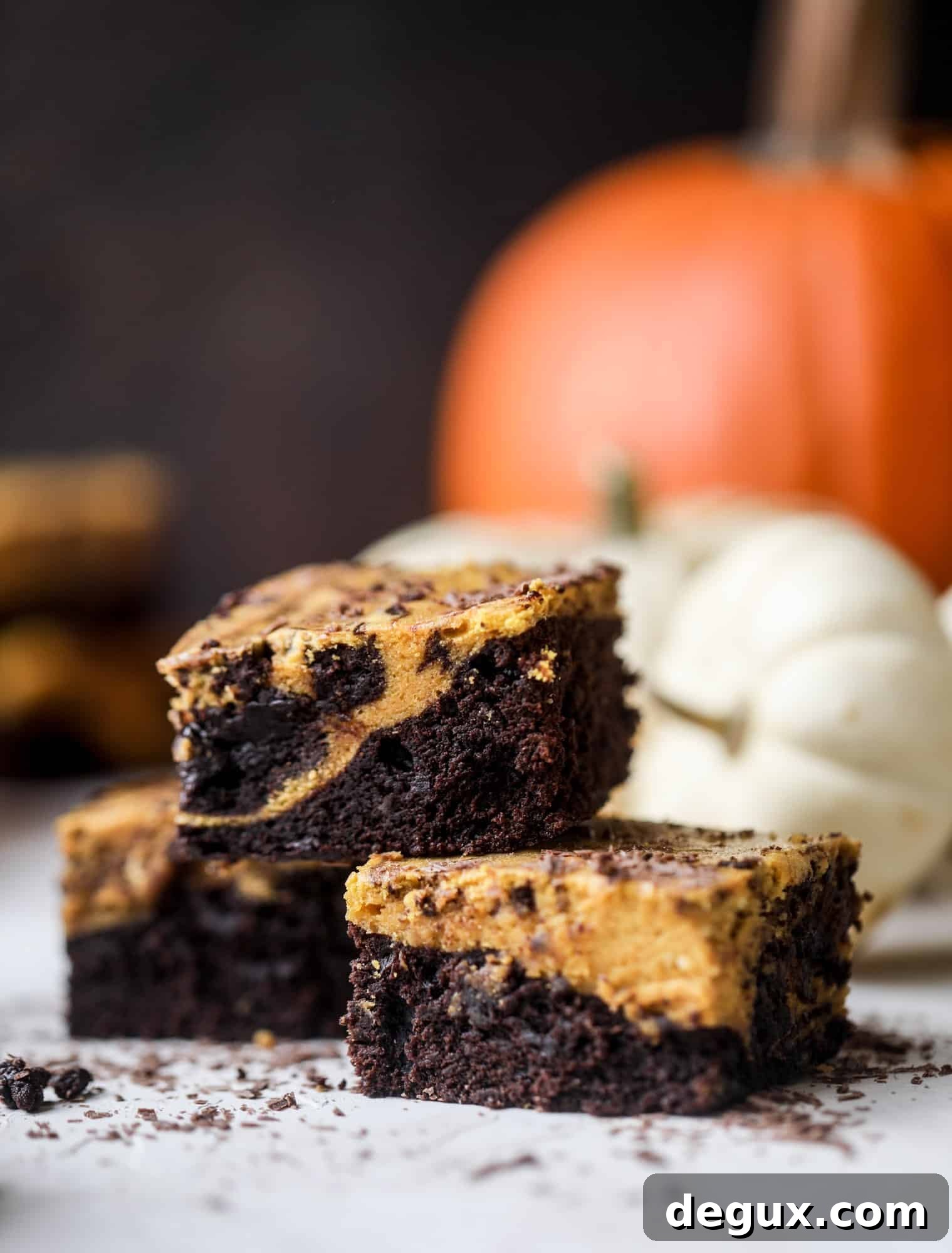 These pumpkin brownies have a fudgy layer of chocolate on the bottom and a silky layer of pumpkin on top! They are so delicious and rich and perfect for fall. The pumpkin brownies come together easily and can be made ahead of time too!