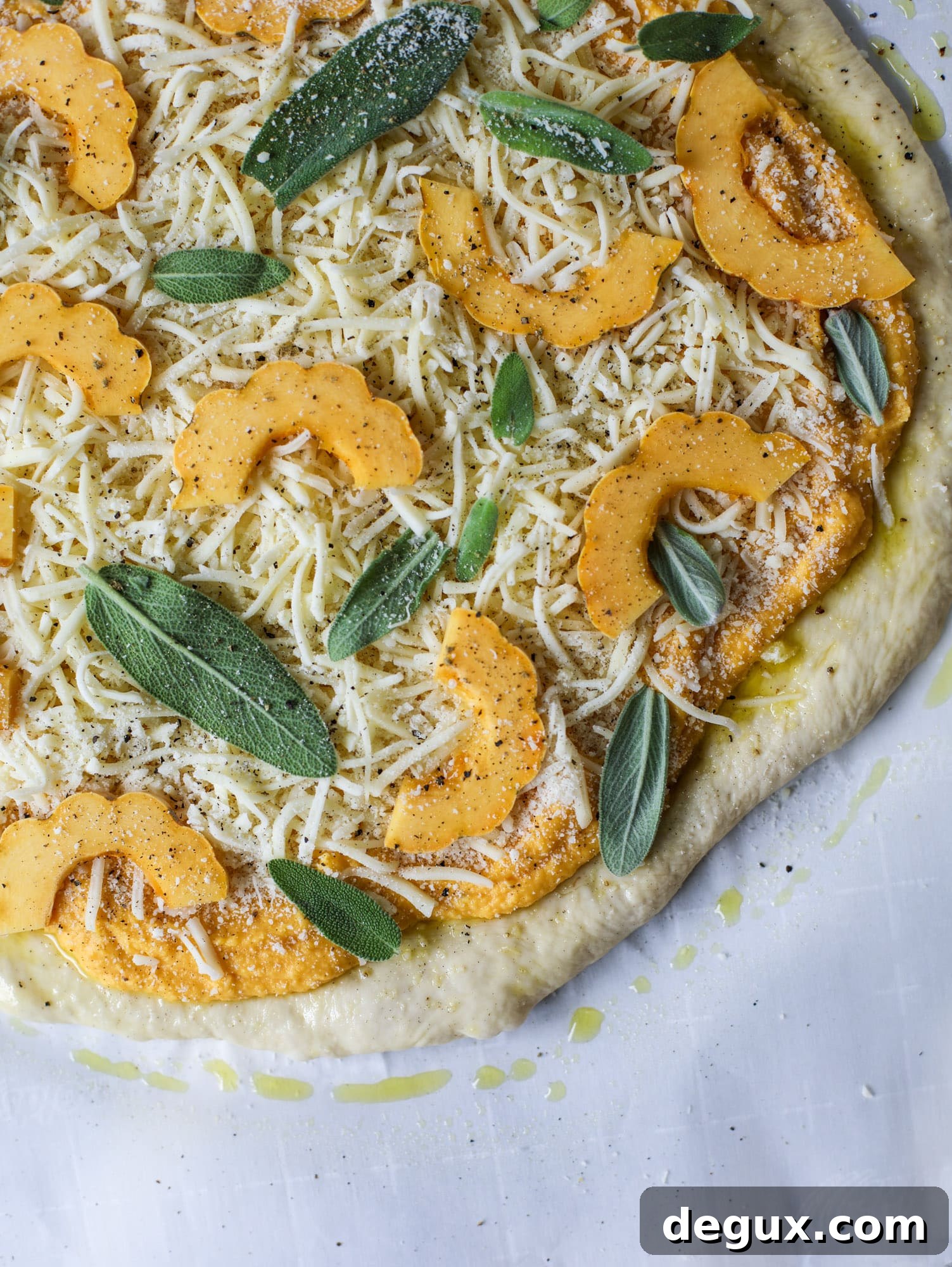 This butternut squash pizza has all the perfect tastes of fall in a pizza! Creamy butternut squash base, sharp parmesan cheese, crispy, fresh sage - it's all these and so super flavorful. It's easy too! I howsweeteats.com #butternutsquash #pizza