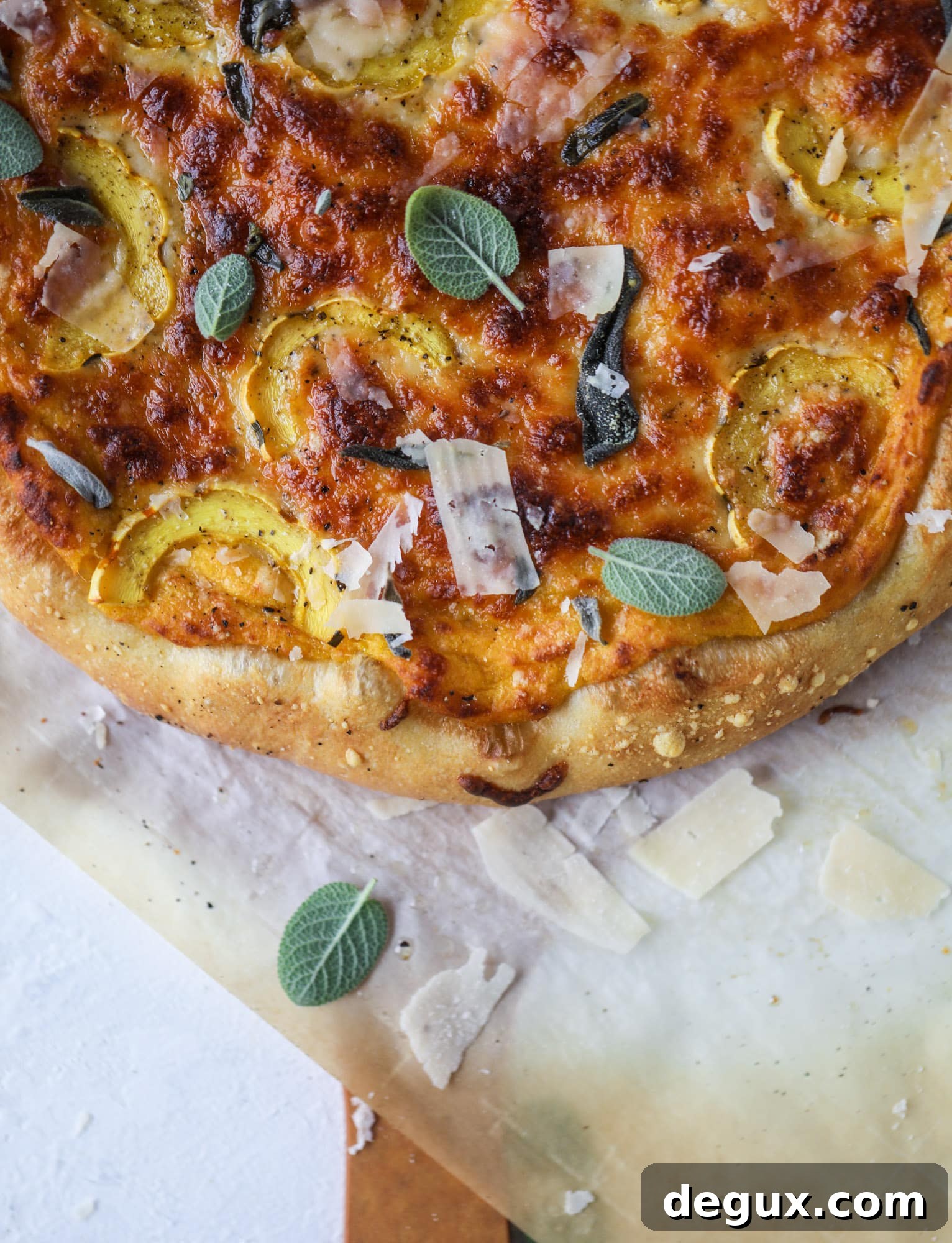 This butternut squash pizza has all the perfect tastes of fall in a pizza! Creamy butternut squash base, sharp parmesan cheese, crispy, fresh sage - it's all these and so super flavorful. It's easy too! I howsweeteats.com #butternutsquash #pizza