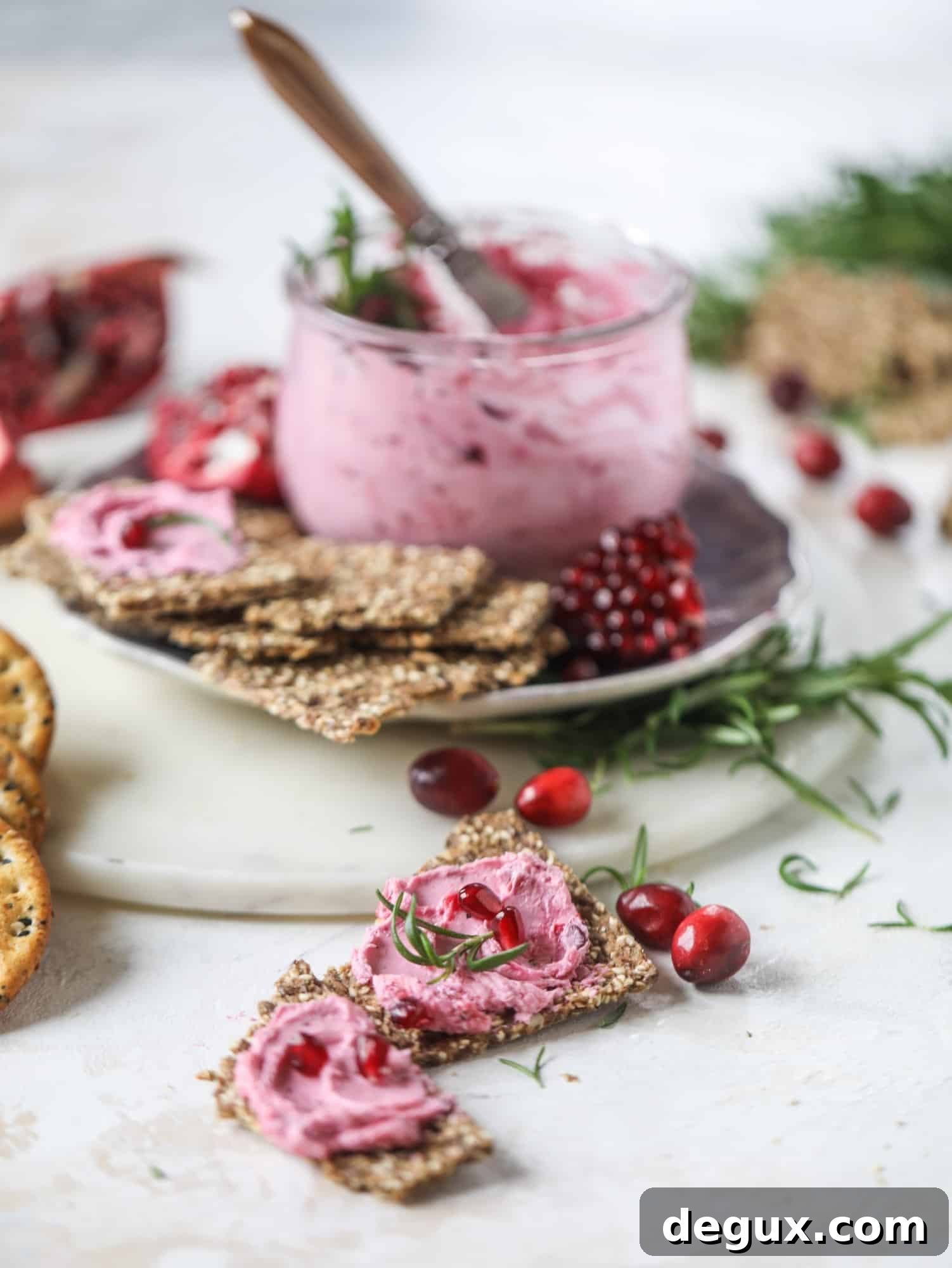 This whipped cranberry goat cheese spread is the perfect holiday appetizer! You can make it ahead of time and serve it with a cheese board or bread and crackers - before or during the meal! Plus it's super pretty too! I howsweeteats.com #cranberry #goatcheese