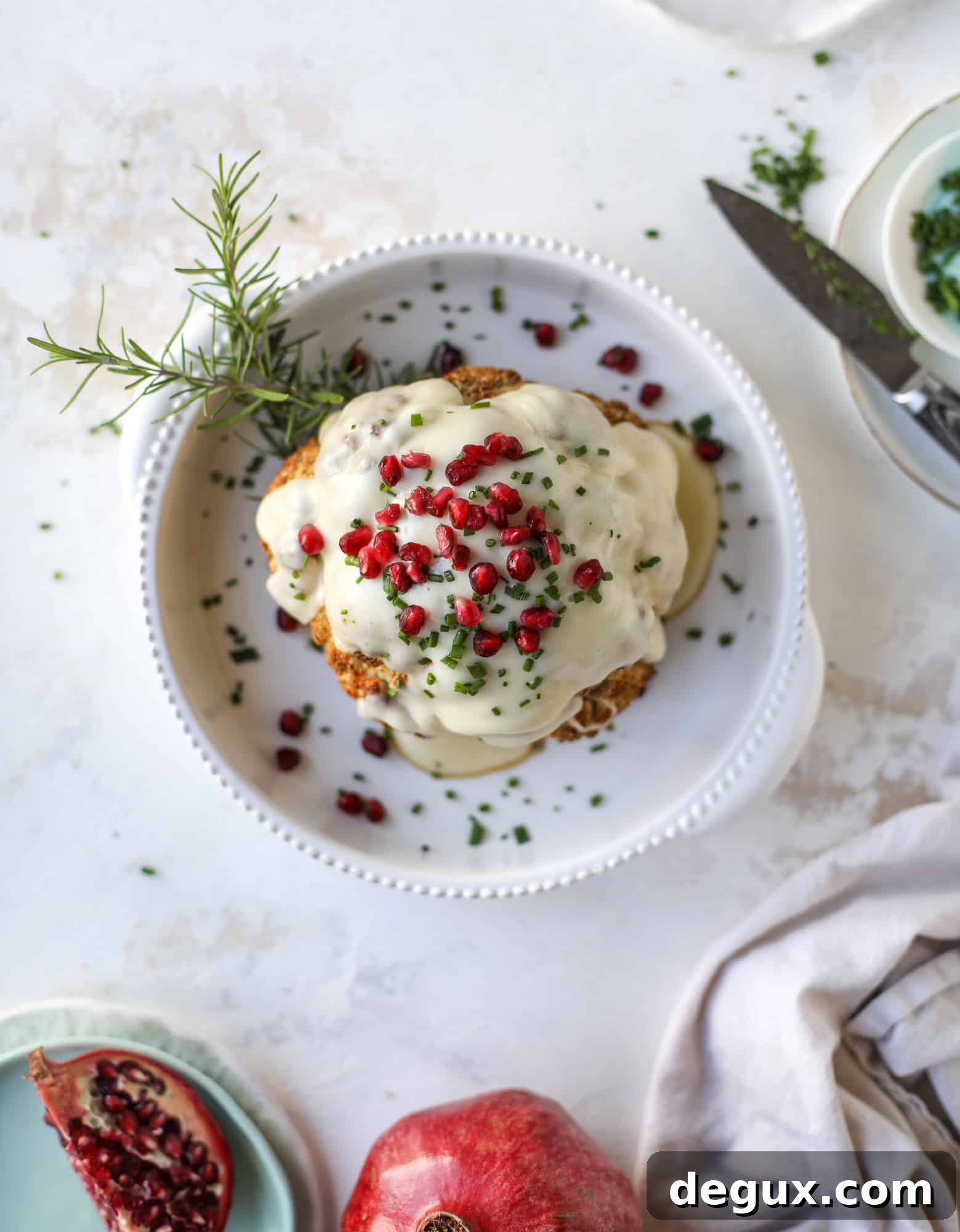 This whole roasted cauliflower fondue is roasted to toasty perfection and then covered in a fondue cheese sauce! Sprinkled with a festive garnish, it's the perfect appetizer or side dish for your dinner party, weeknight meal or movie night! I howsweeteats.com #wholeroasted #cauliflower