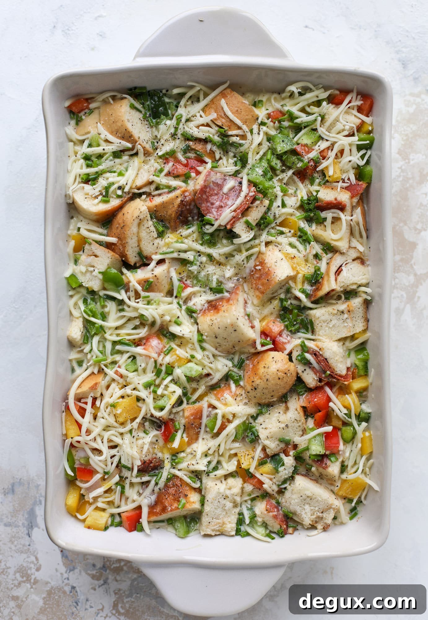 This breakfast strata is super special because the base is built on pepperoni rolls! This make ahead casserole is perfect for holiday brunches or parties and tastes like a supreme pizza. It's so easy to throw together too! I howsweeteats.com #breakfast #strata