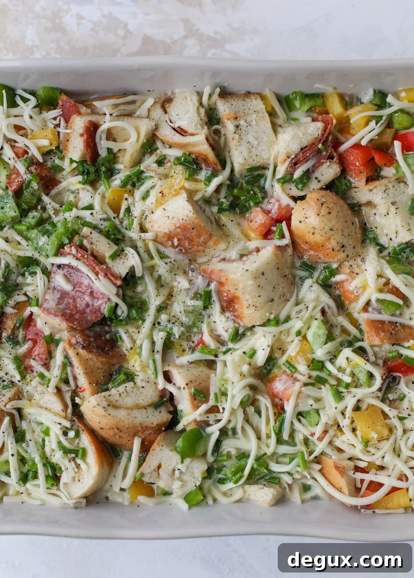 This breakfast strata is super special because the base is built on pepperoni rolls! This make ahead casserole is perfect for holiday brunches or parties and tastes like a supreme pizza. It's so easy to throw together too! I howsweeteats.com #breakfast #strata