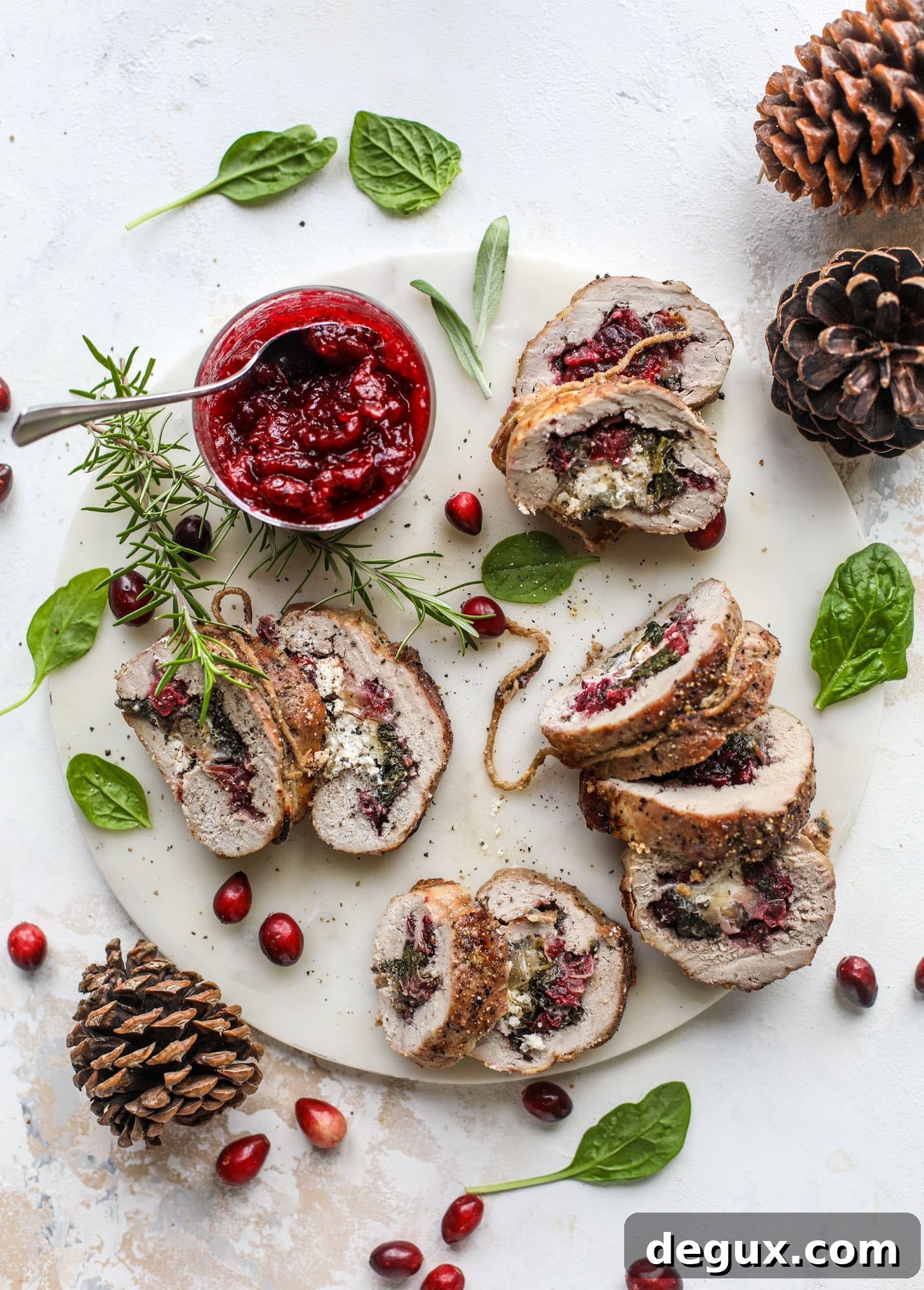 Holiday Stuffed Pork Tenderloin Recipe for Festive Dinners 2 This holiday stuffed pork tenderloin is filled with caramelized onion, fresh cranberry sauce, goat cheese and fresh spinach. It's a show stopper and super delicious, along with being fairly simple to make!