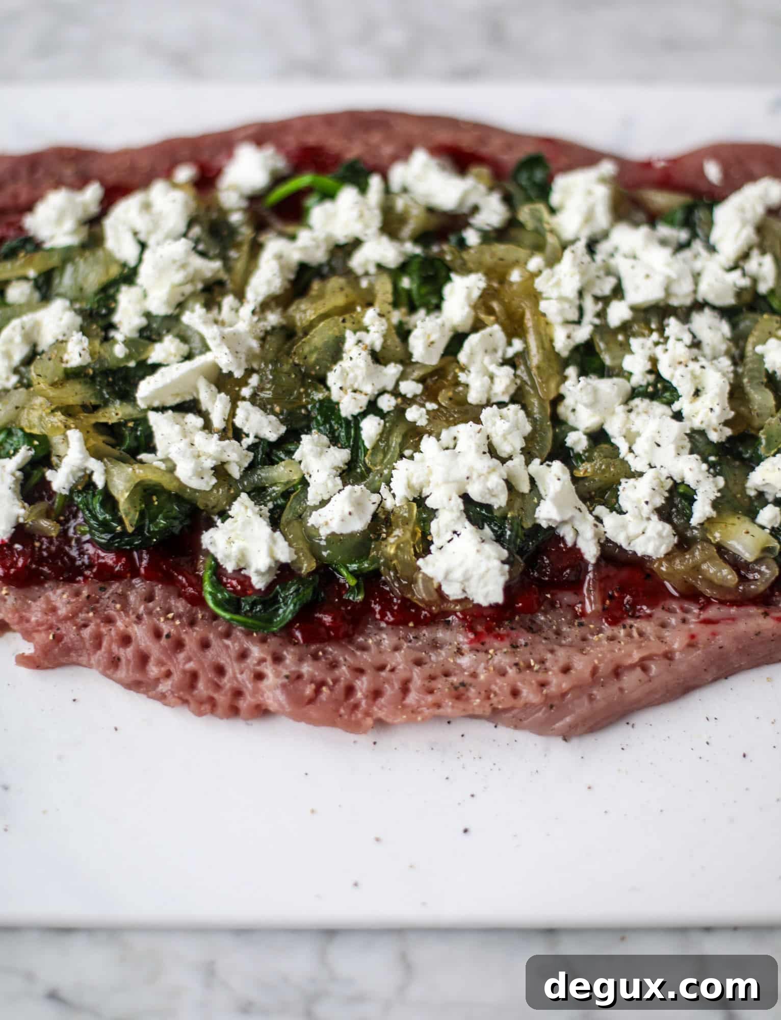 Holiday Stuffed Pork Tenderloin Recipe for Festive Dinners 3 This holiday stuffed pork tenderloin is filled with caramelized onion, fresh cranberry sauce, goat cheese and fresh spinach. It's a show stopper and super delicious, along with being fairly simple to make!