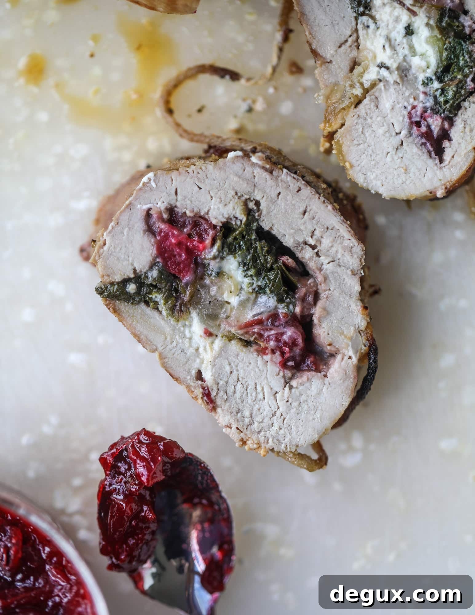 Holiday Stuffed Pork Tenderloin Recipe for Festive Dinners 5 This holiday stuffed pork tenderloin is filled with caramelized onion, fresh cranberry sauce, goat cheese and fresh spinach. It's a show stopper and super delicious, along with being fairly simple to make!