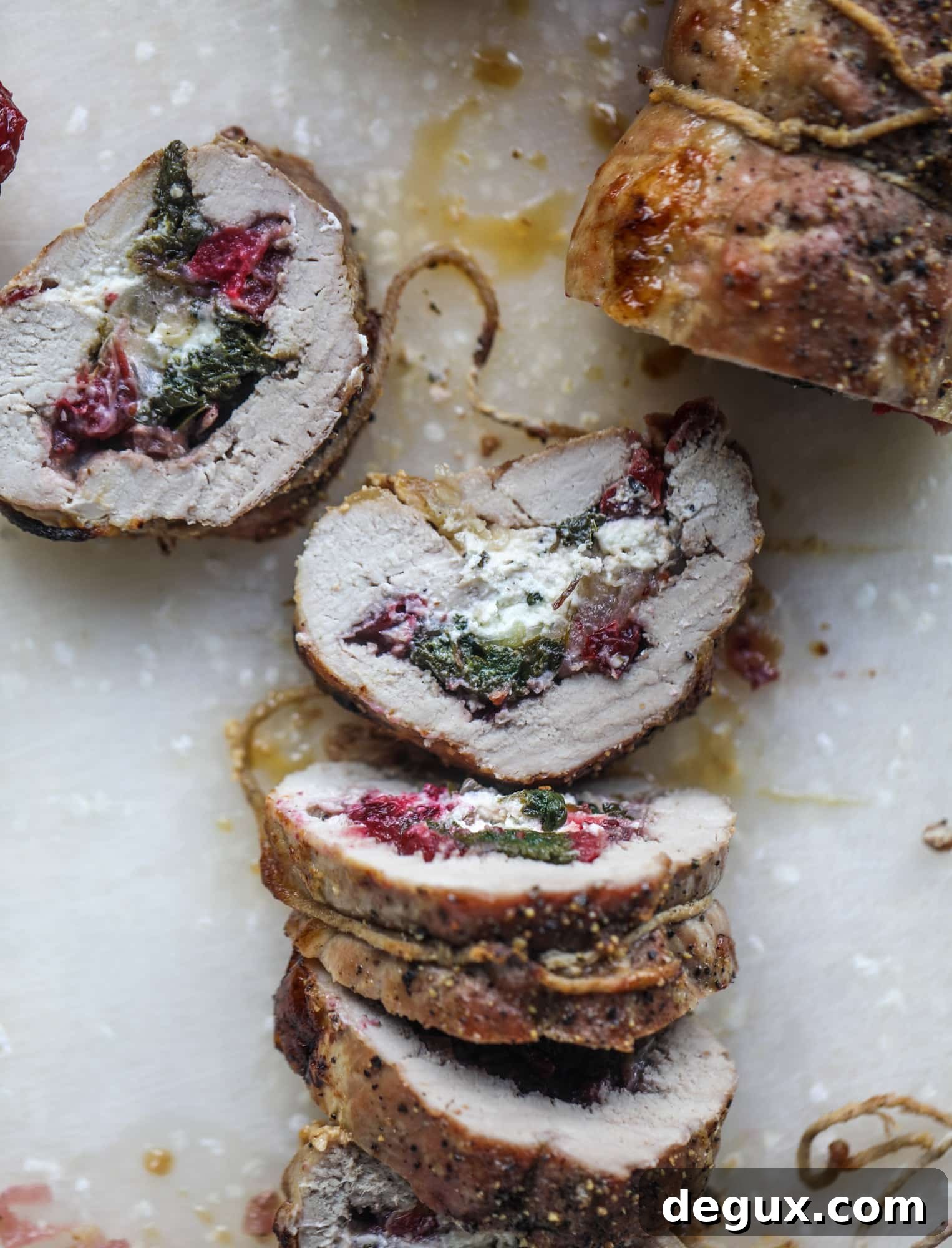 Holiday Stuffed Pork Tenderloin Recipe for Festive Dinners 6 This holiday stuffed pork tenderloin is filled with caramelized onion, fresh cranberry sauce, goat cheese and fresh spinach. It's a show stopper and super delicious, along with being fairly simple to make!