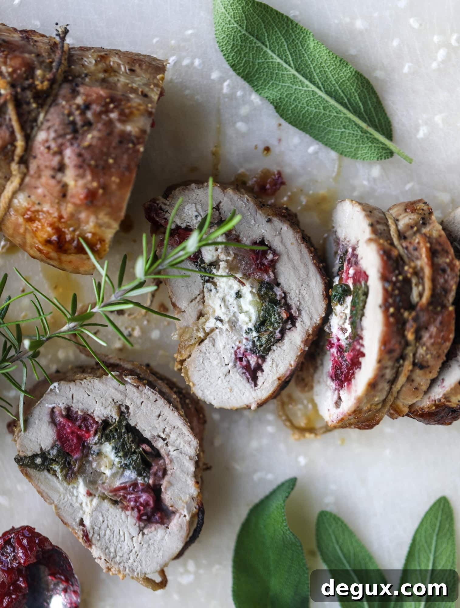 Holiday Stuffed Pork Tenderloin Recipe for Festive Dinners 7 This holiday stuffed pork tenderloin is filled with caramelized onion, fresh cranberry sauce, goat cheese and fresh spinach. It's a show stopper and super delicious, along with being fairly simple to make!