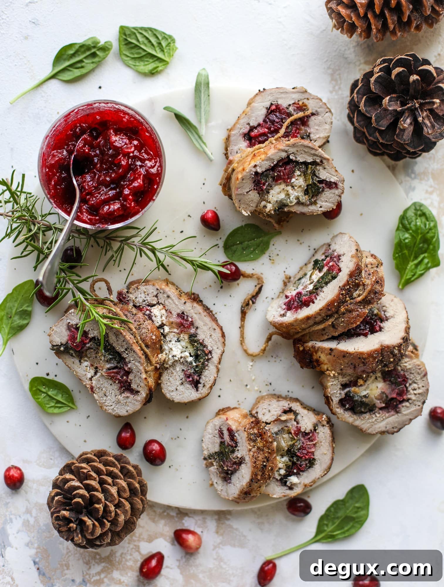 Holiday Stuffed Pork Tenderloin Recipe for Festive Dinners 8 This holiday stuffed pork tenderloin is filled with caramelized onion, fresh cranberry sauce, goat cheese and fresh spinach. It's a show stopper and super delicious, along with being fairly simple to make!