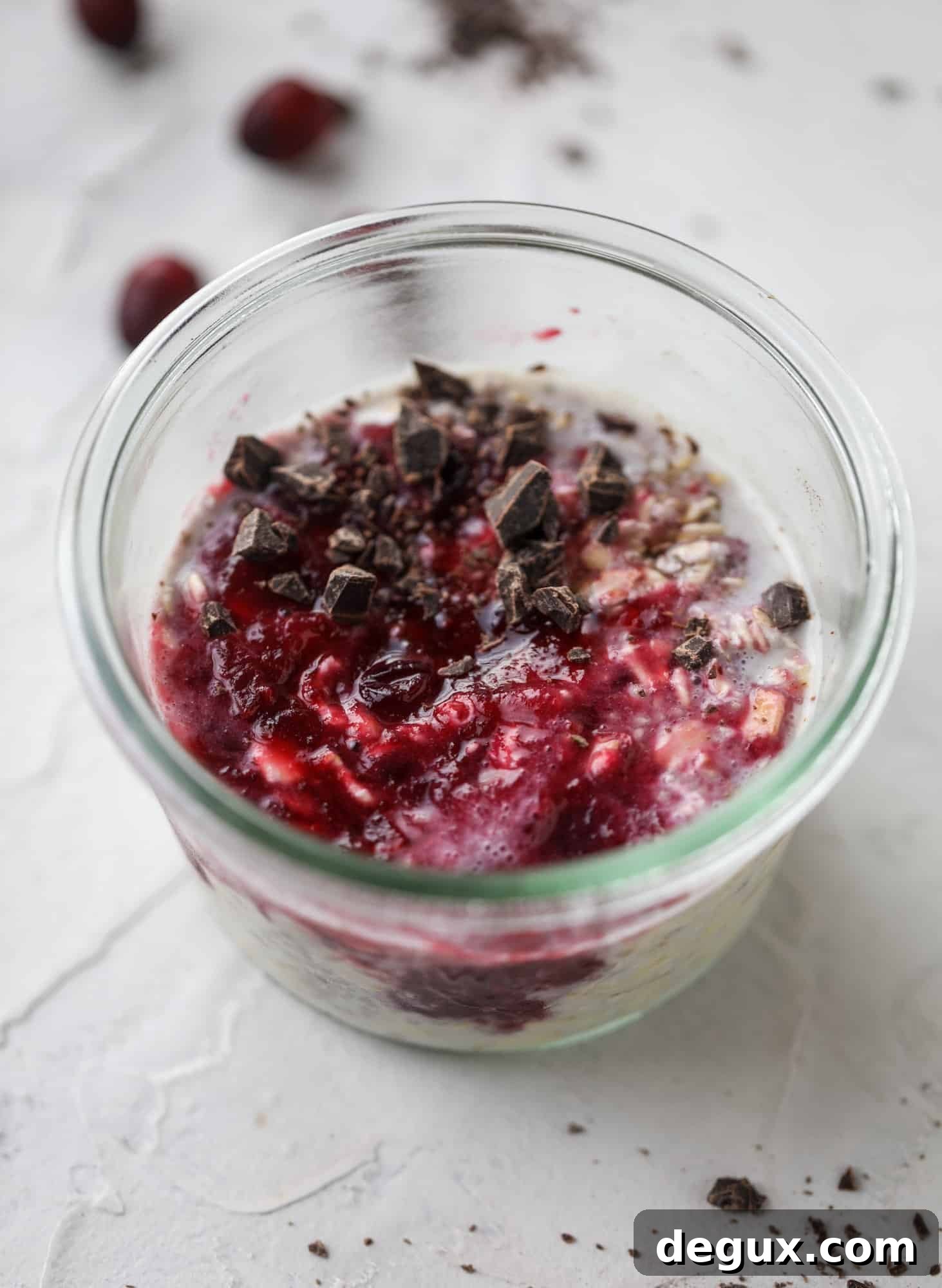 These leftover cranberry overnight oats are the perfect post-Thanksgiving breakfast! Leftover cranberry sauce and dark chocolate come together to flavor chewy, chilled overnight oats. Add on sliced almonds, chia seeds and hemp hearts for more deliciousness! I howsweeteats.com #overnight #oats