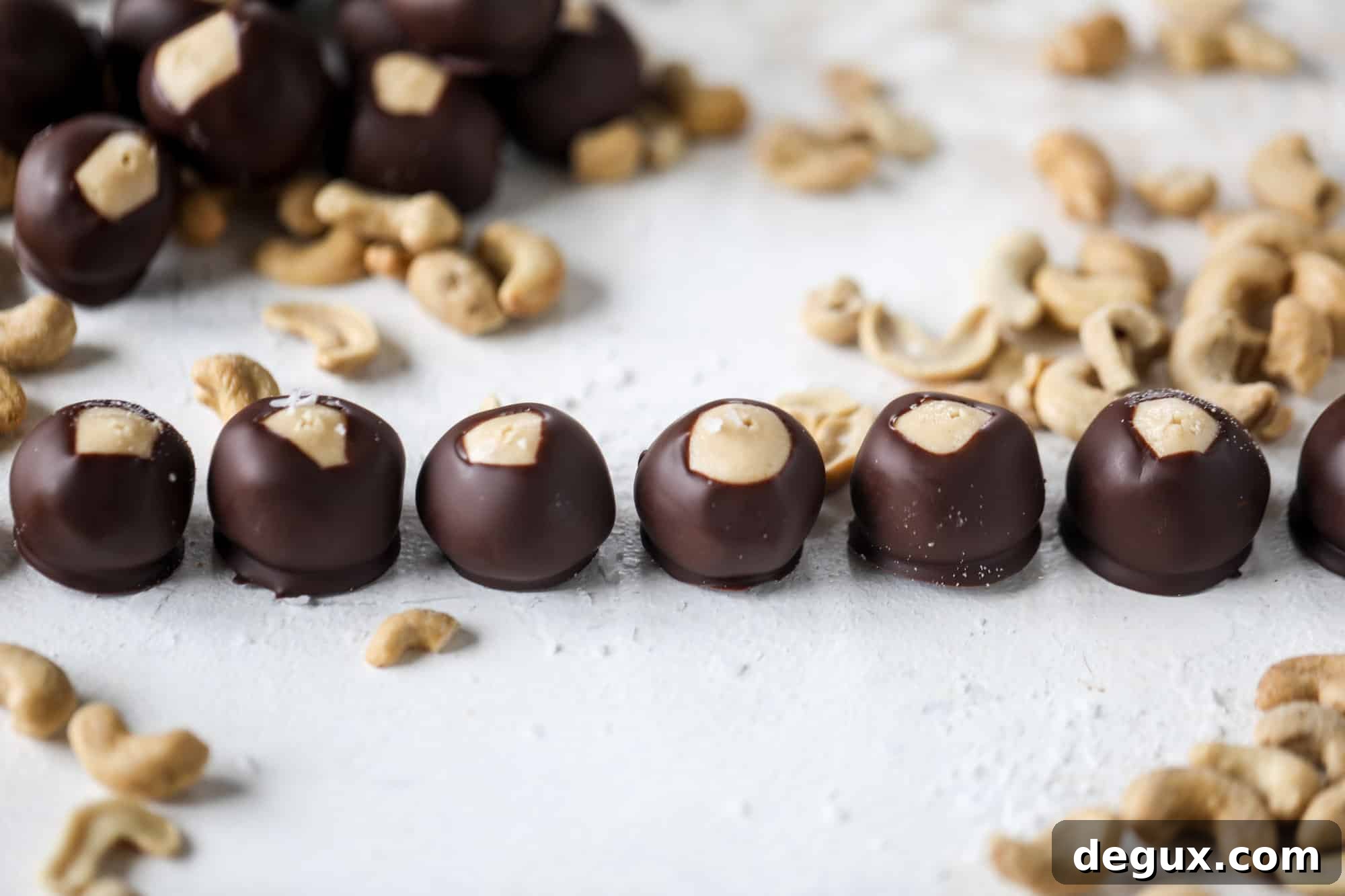 These cashew butter buckeyes are a fun and modern twist on the traditional buckeye recipe! Creamy cashew butter makes a delicious, rich dough and then it's coated in chocolate and sprinkled with sea salt. Delicious! I howsweeteats.com #cashewbutter #buckeyes