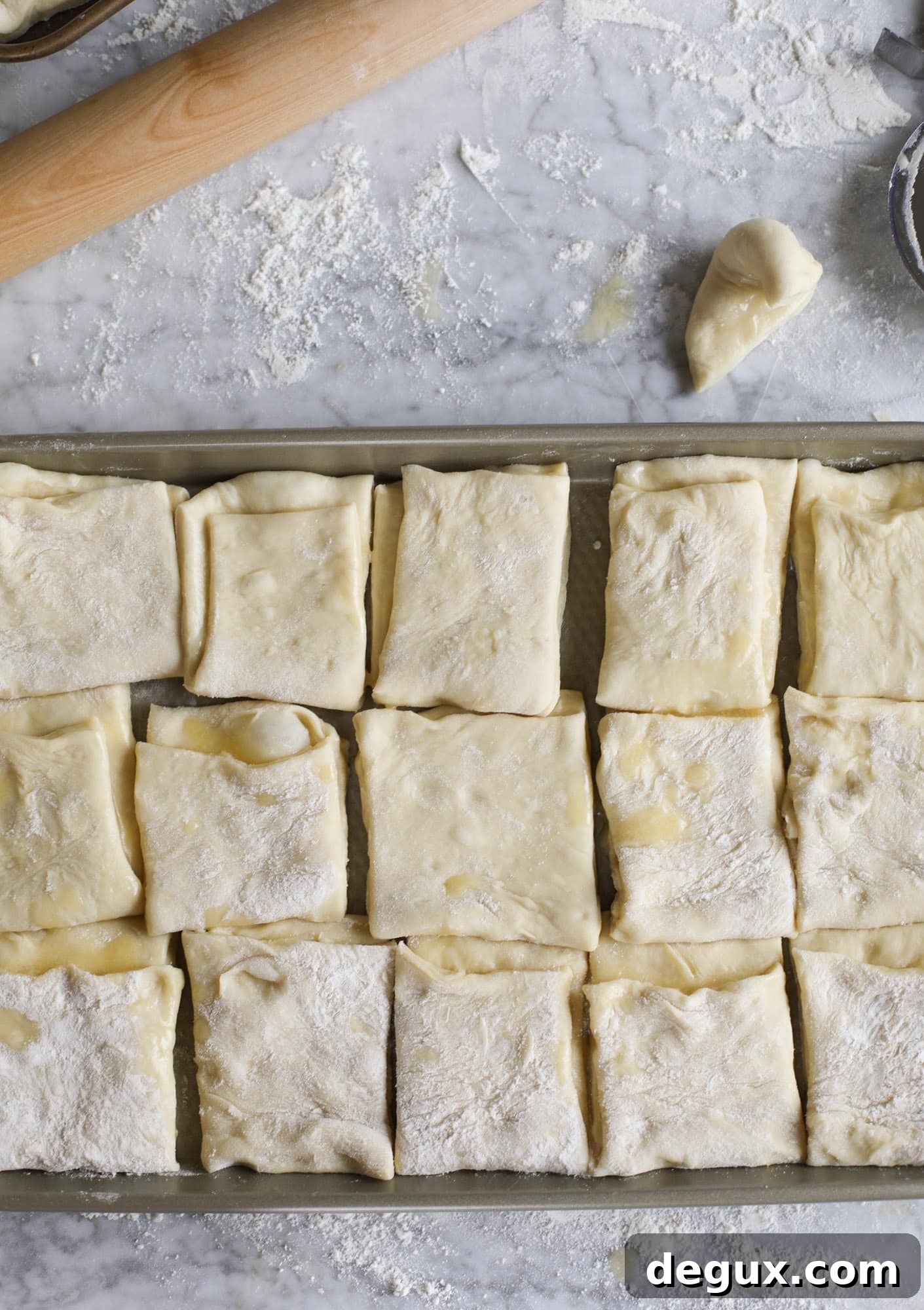 Garlic herb parker house rolls are full of incredibly buttery flavor! They are brushed with a garlic herb butter and are super fluffy, soft and tender. Perfect for Thanksgiving or the holidays and you can make the dough a bit ahead of time! I howsweeteats.com #parkerhouse #rolls