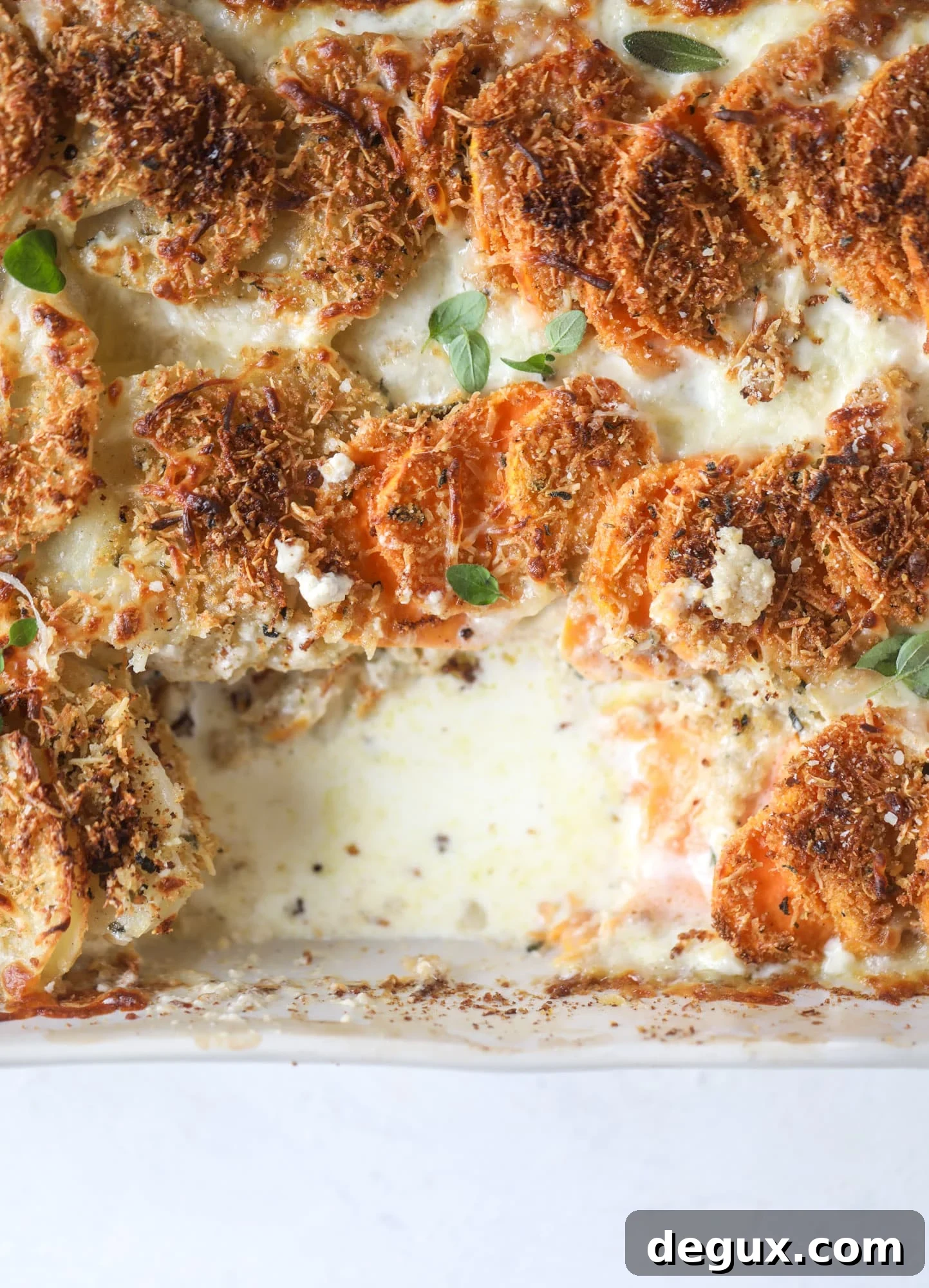 Asiago Scalloped Potatoes: Classic and Crispy Variations 2 These scalloped potatoes are a cheese lover's dream. Sharp asiago and cream envelops idaho and sweet potatoes in these scalloped potatoes to please everyone! The crunchy asiago topping is irresistible. I howsweeteats.com #scalloped #potatoes