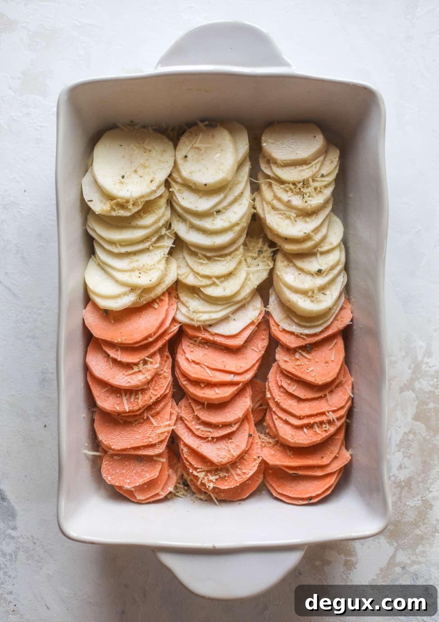 These scalloped potatoes are a cheese lover's dream. Sharp asiago and cream envelops idaho and sweet potatoes in these scalloped potatoes to please everyone! The crunchy asiago topping is irresistible. I howsweeteats.com #scalloped #potatoes
