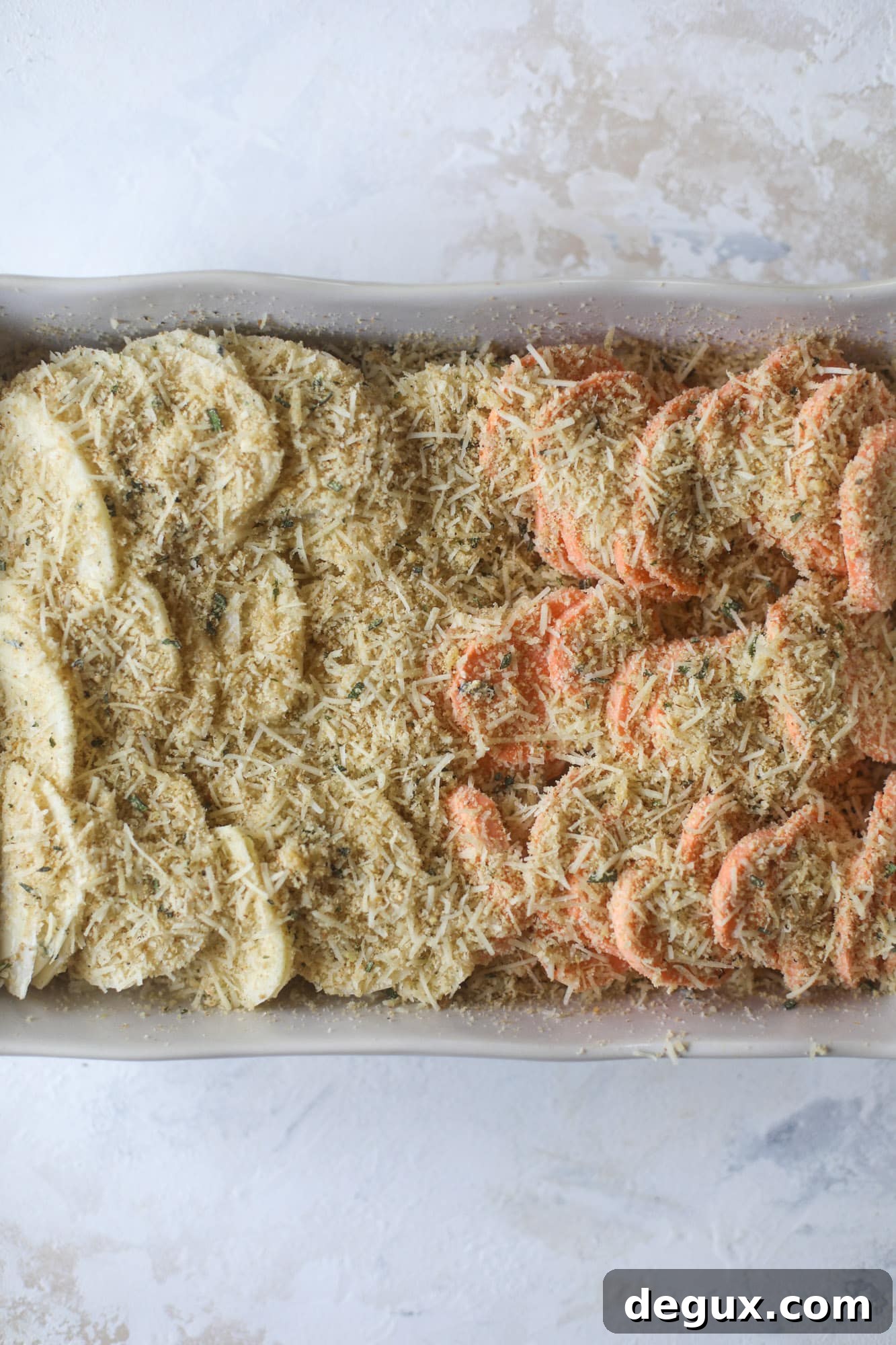 These scalloped potatoes are a cheese lover's dream. Sharp asiago and cream envelops idaho and sweet potatoes in these scalloped potatoes to please everyone! The crunchy asiago topping is irresistible. I howsweeteats.com #scalloped #potatoes