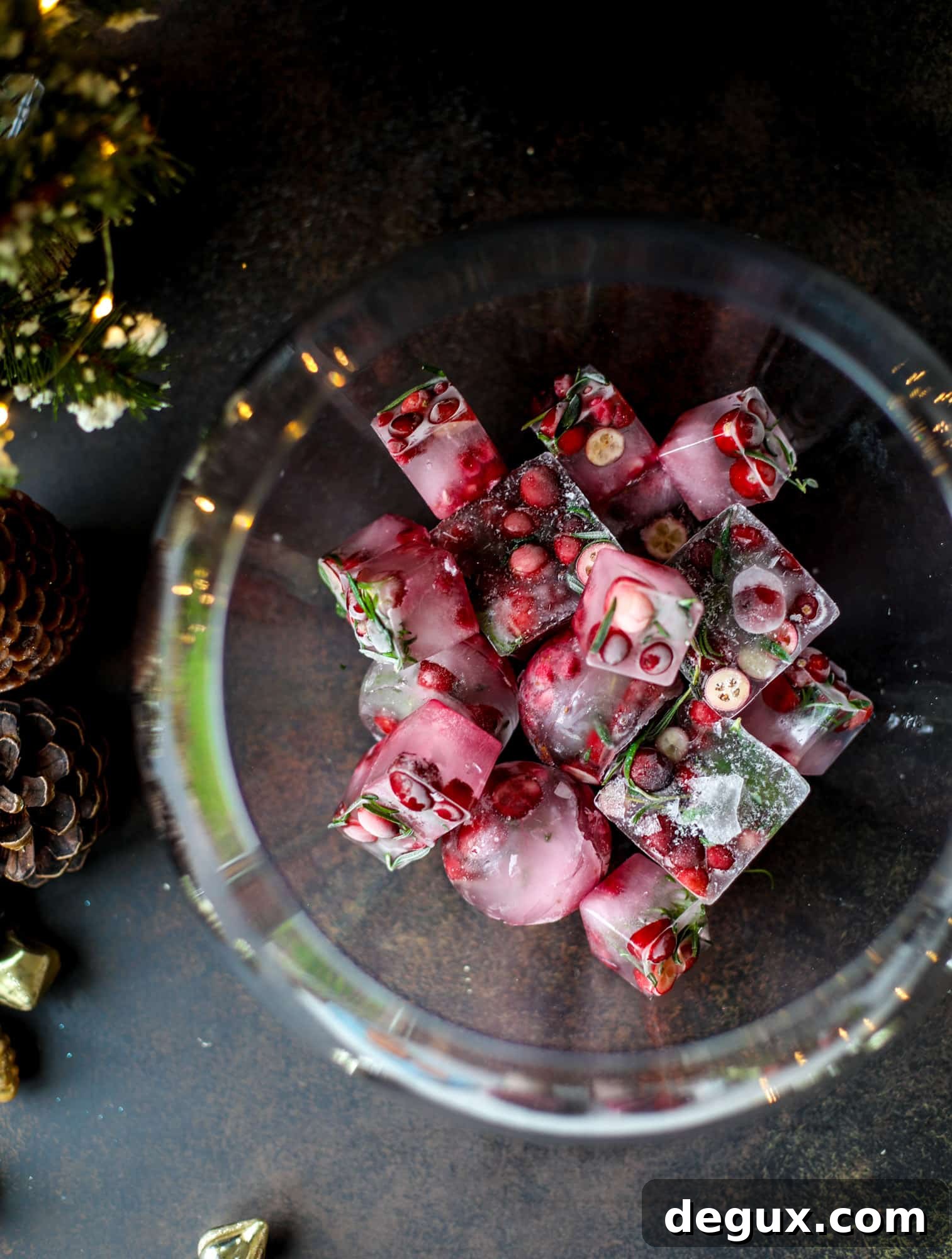 This tree trimming punch is the most perfect Christmas punch to drink while decorating the tree! Rich red wine is the base and there's a bit of orange, some spice, cinnamon and a gorgeous jeweled holiday ice cubes!