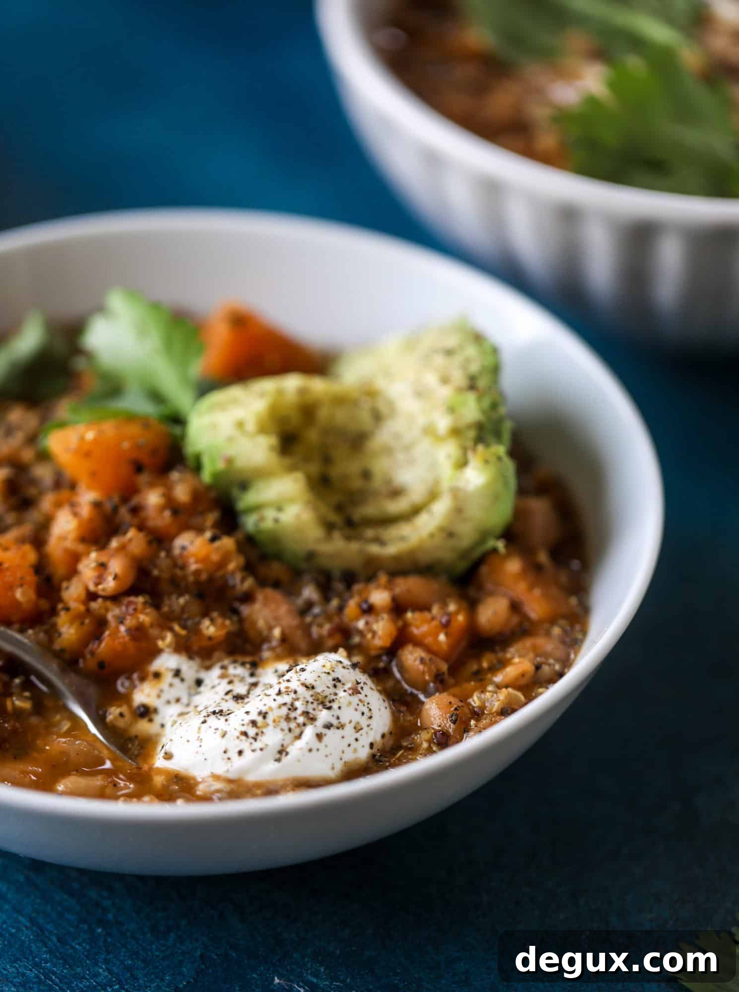 Hearty Butternut Squash and Quinoa Chili Recipe 8 This butternut squash chili is super satisfying and delicious! It's made with pinto beans and quinoa, comes together quickly and is filling and perfect to reheat for lunches. Everything you want in a vegetarian chili!
