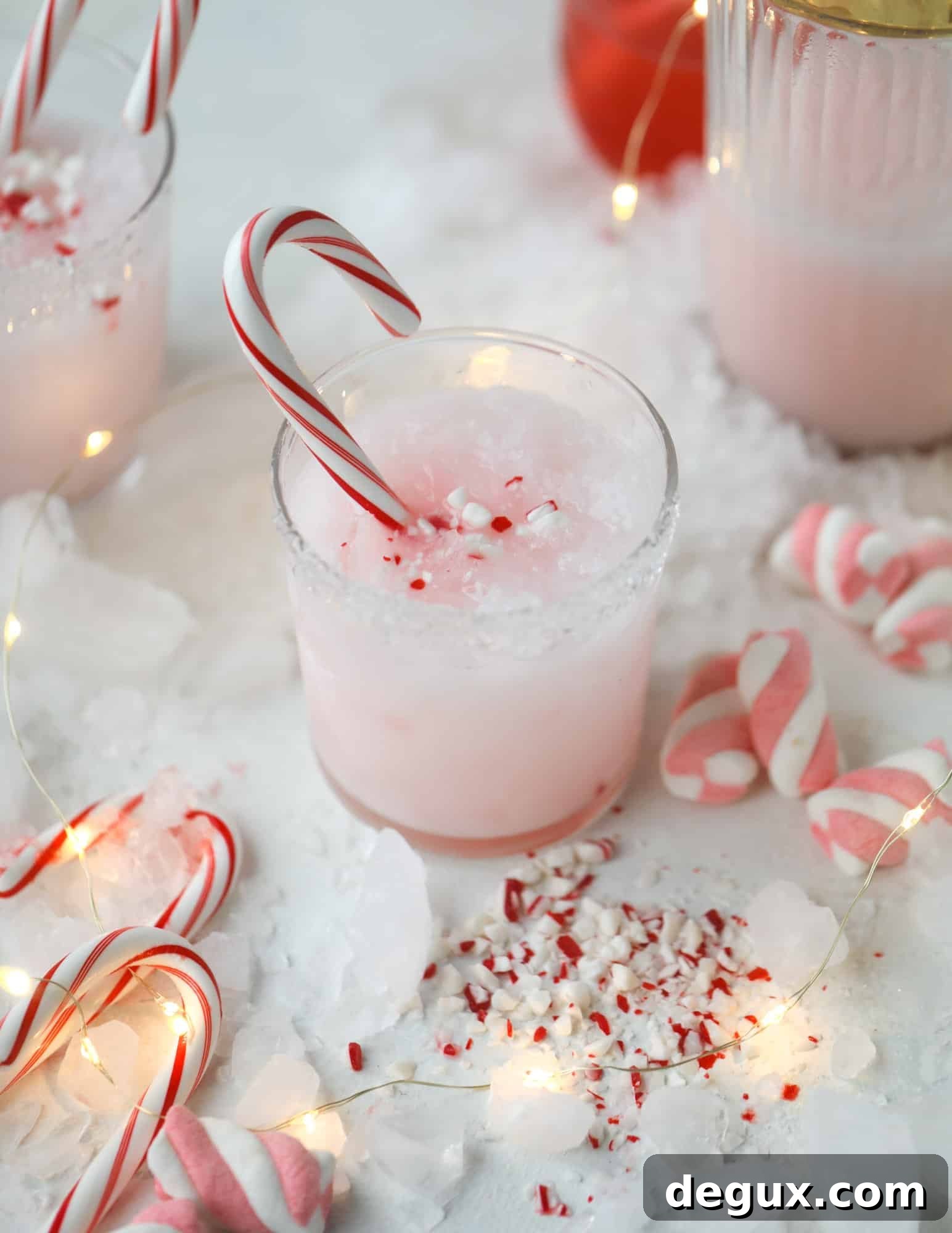 This pink peppermint cocktail is full of holiday cheer! Candy cane vodka, creme de cacao, vanilla and a drop of cream come together to create the perfect iced holiday drink that tastes like a treat! I howsweeteats.com #pinkpeppermint #cocktail