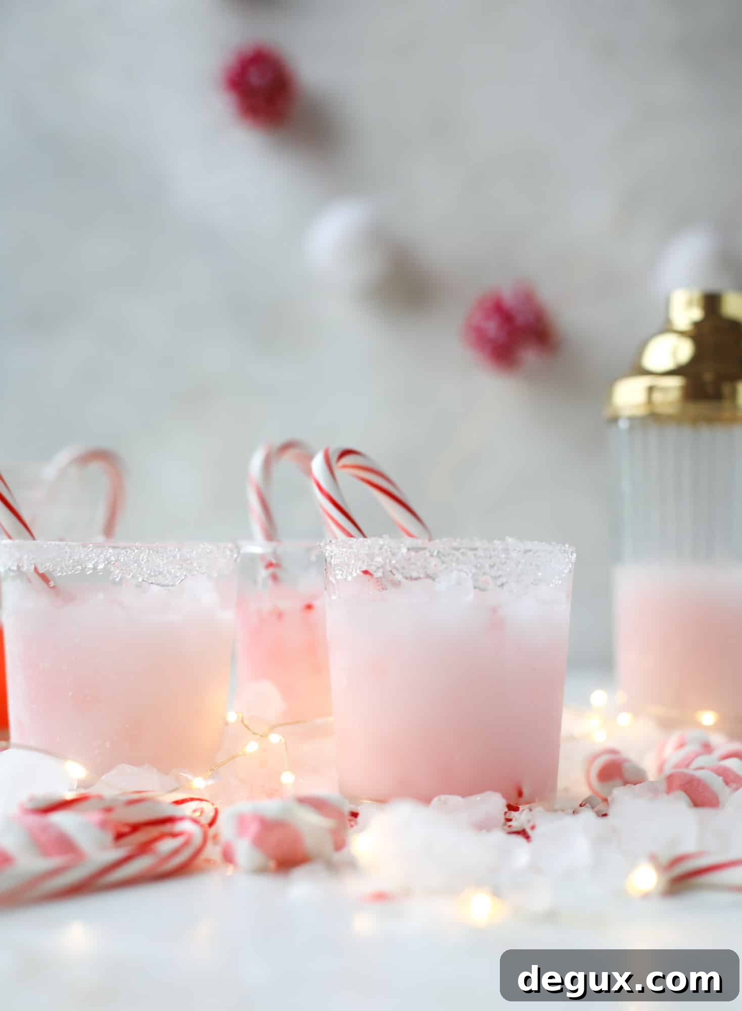This pink peppermint cocktail is full of holiday cheer! Candy cane vodka, creme de cacao, vanilla and a drop of cream come together to create the perfect iced holiday drink that tastes like a treat! I howsweeteats.com #pinkpeppermint #cocktail
