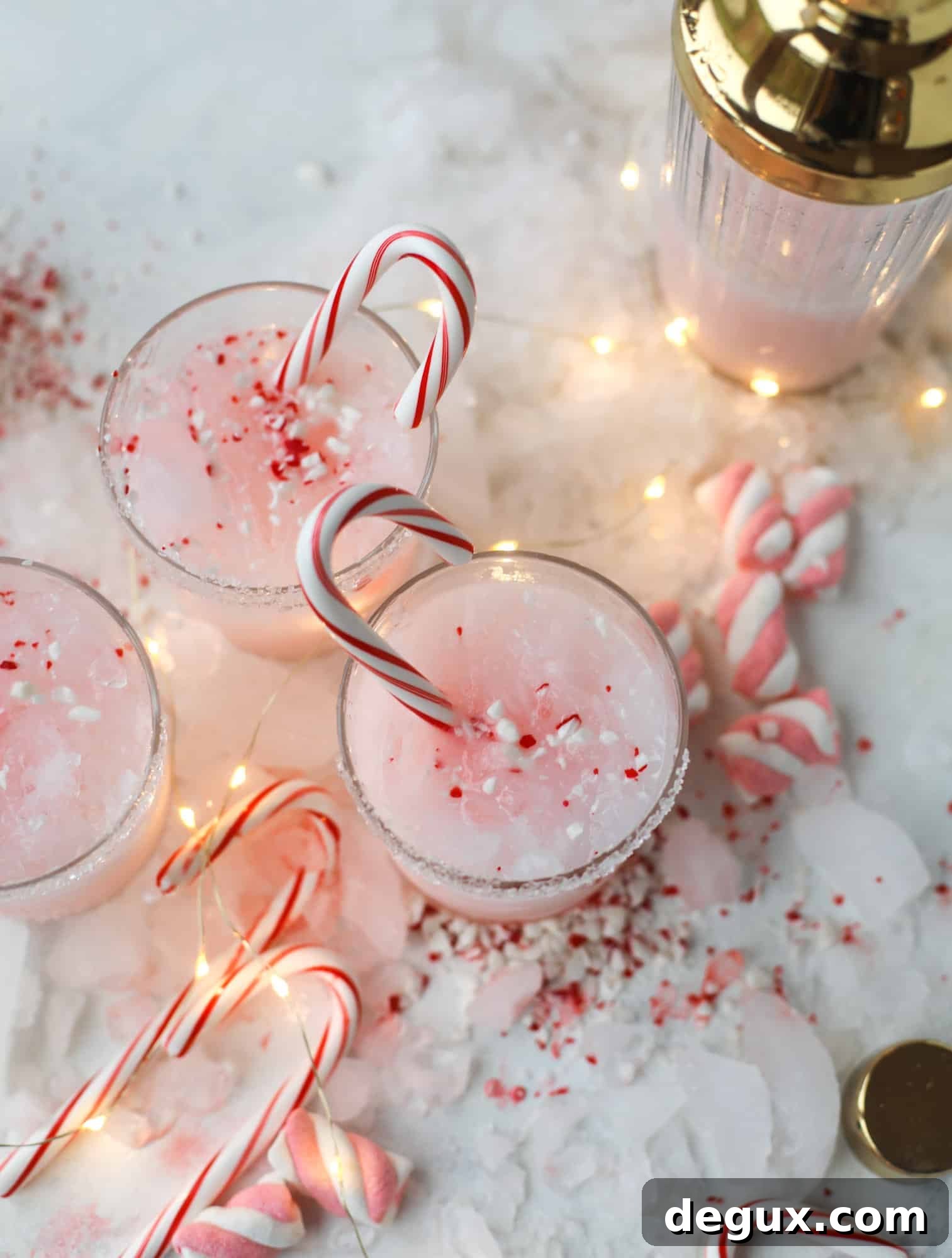 This pink peppermint cocktail is full of holiday cheer! Candy cane vodka, creme de cacao, vanilla and a drop of cream come together to create the perfect iced holiday drink that tastes like a treat! I howsweeteats.com #pinkpeppermint #cocktail