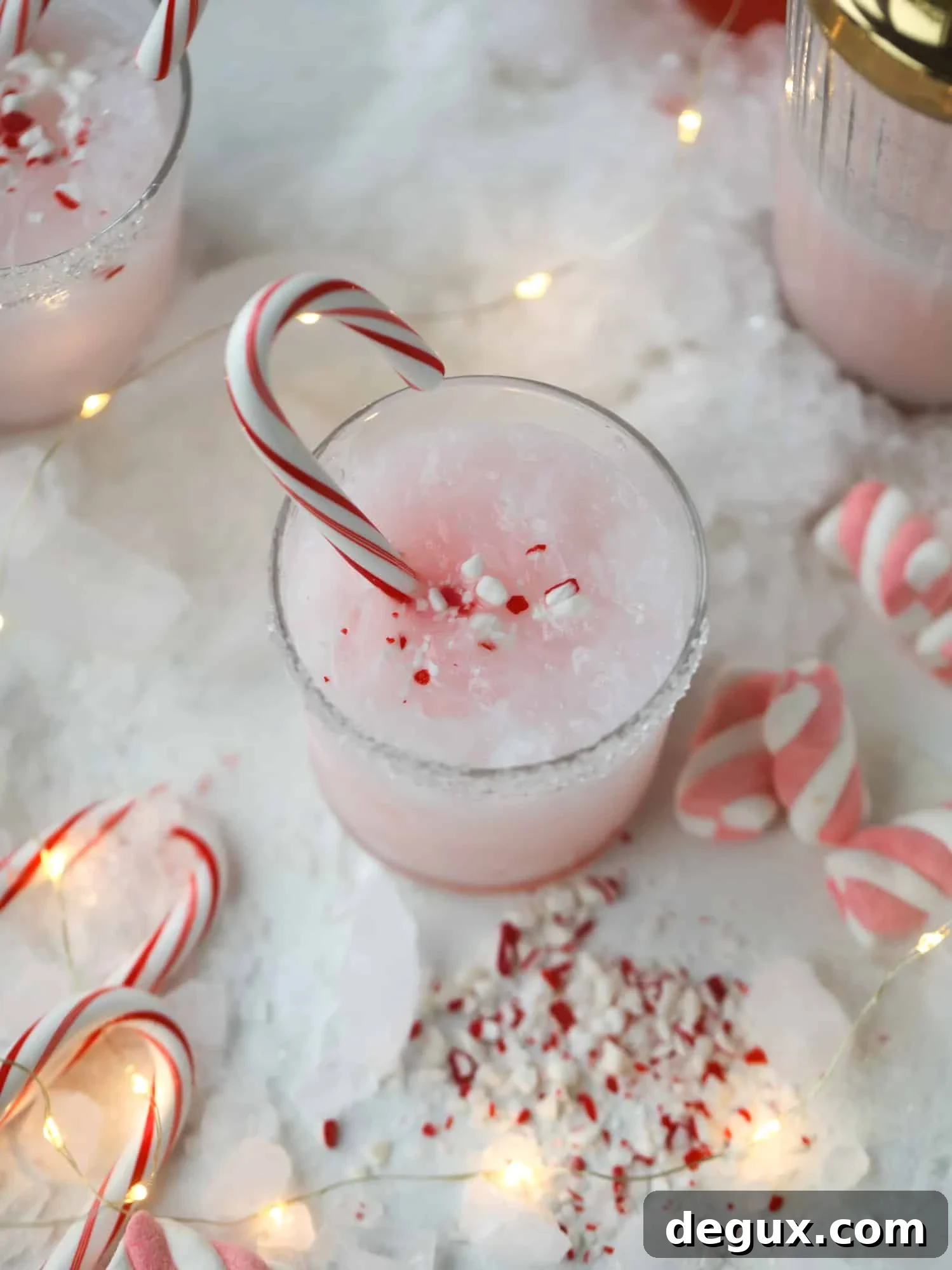 This pink peppermint cocktail is full of holiday cheer! Candy cane vodka, creme de cacao, vanilla and a drop of cream come together to create the perfect iced holiday drink that tastes like a treat! I howsweeteats.com #pinkpeppermint #cocktail