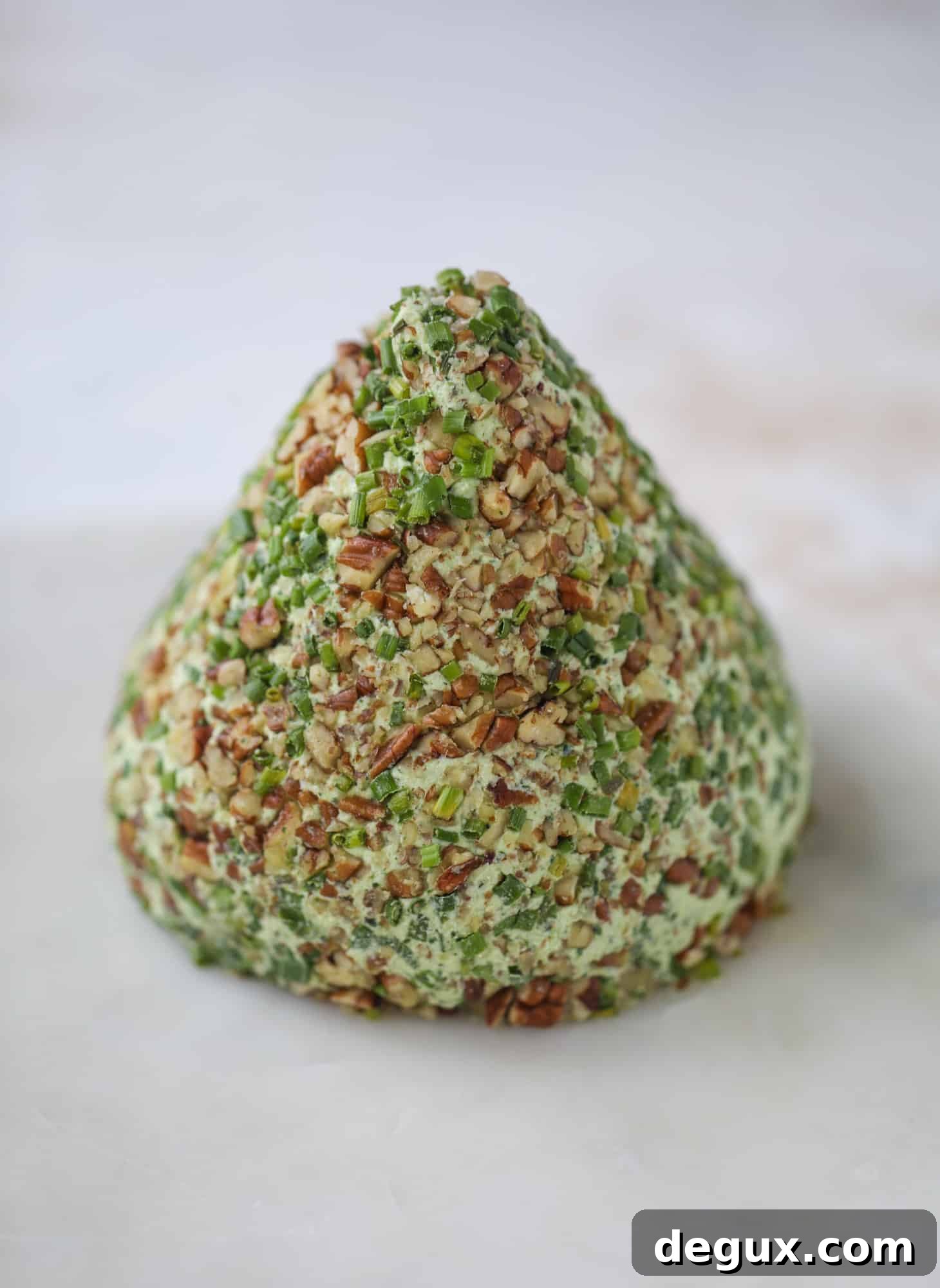 Creamy Green Goddess Cheese Ball Recipe for Parties 3 This green goddess cheese ball is the perfect party snack! You can make it ahead of time and shape it into a cute tree for a festive look. Serve it with crispy crackers and pita chips!