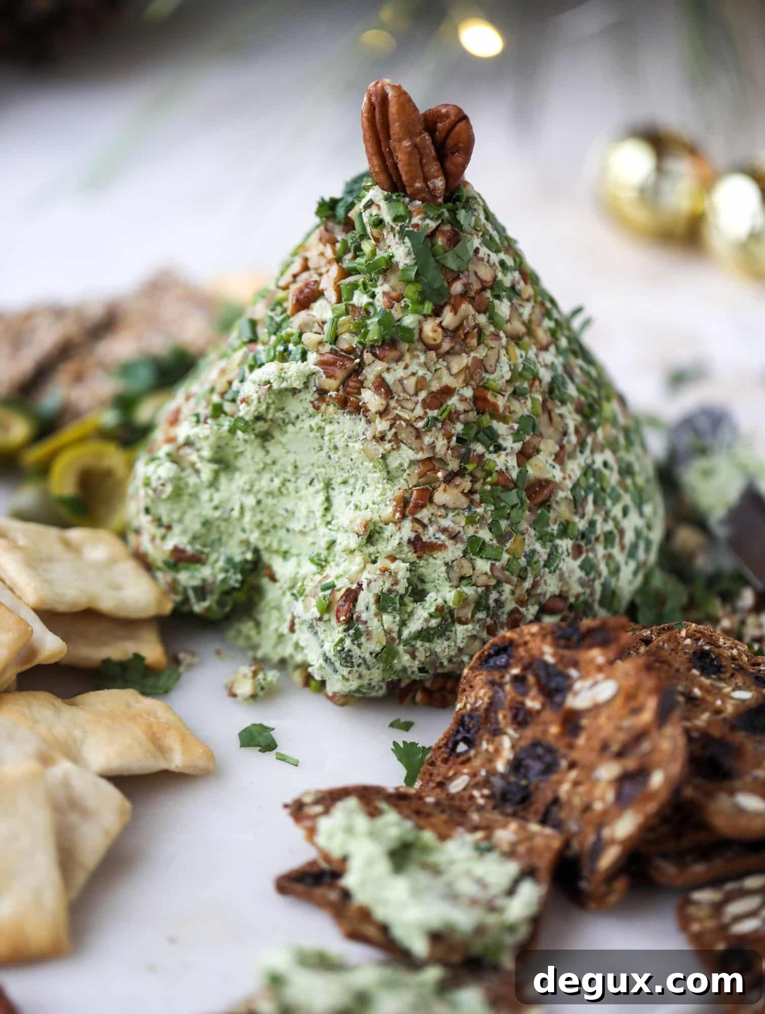 Creamy Green Goddess Cheese Ball Recipe for Parties 5 This green goddess cheese ball is the perfect party snack! You can make it ahead of time and shape it into a cute tree for a festive look. Serve it with crispy crackers and pita chips!