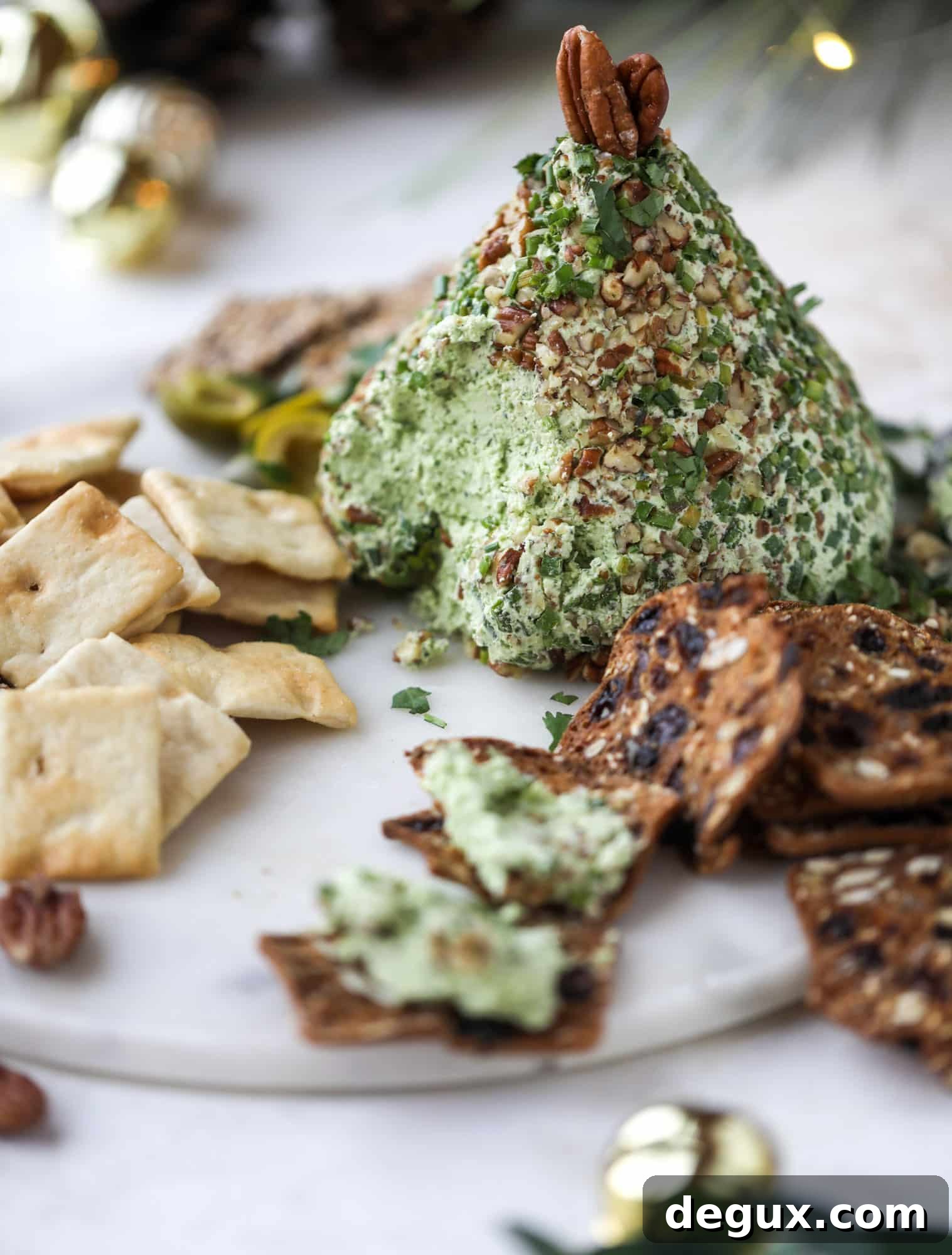 Creamy Green Goddess Cheese Ball Recipe for Parties 6 This green goddess cheese ball is the perfect party snack! You can make it ahead of time and shape it into a cute tree for a festive look. Serve it with crispy crackers and pita chips!