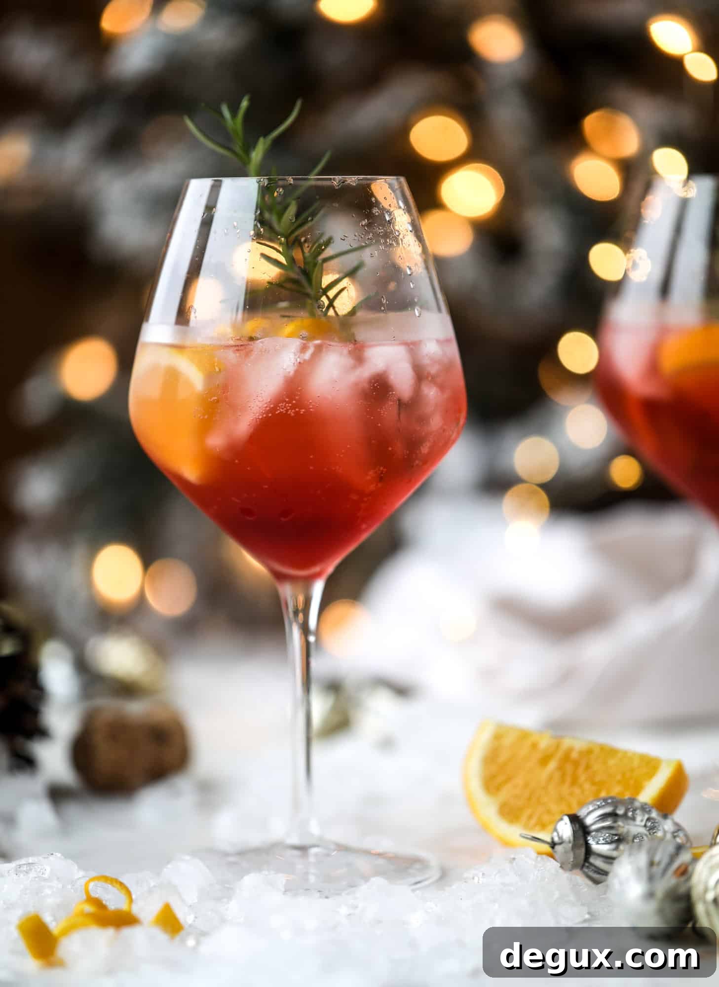 This winter aperol spritz cocktail is a seasonal spin on the classic aperol spritz! Festive cranberry and classic orange come together with prosecco and club soda to create a super light and refreshing cocktail for the holidays! I howsweeteats.com #aperol #spritz