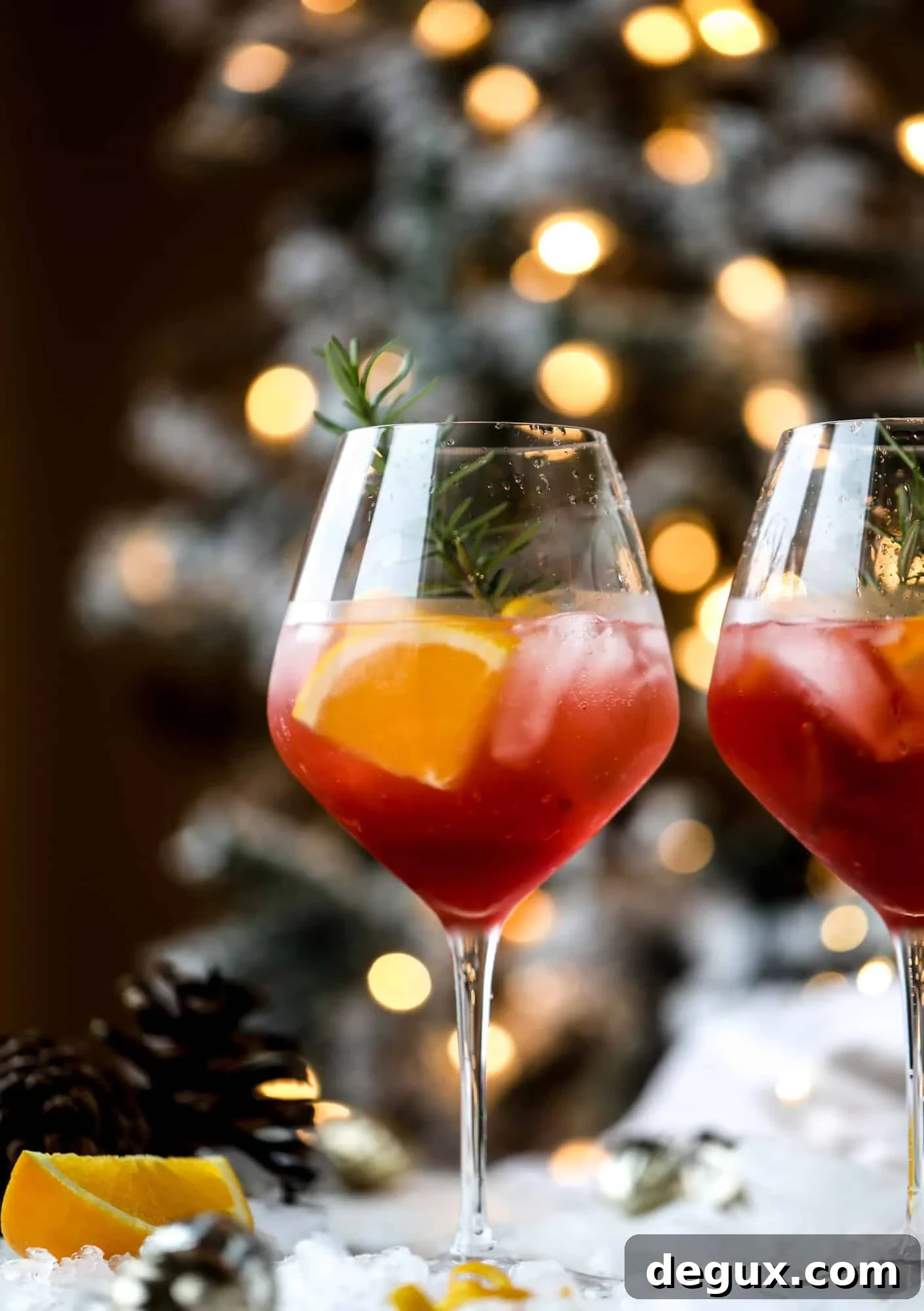 This winter aperol spritz cocktail is a seasonal spin on the classic aperol spritz! Festive cranberry and classic orange come together with prosecco and club soda to create a super light and refreshing cocktail for the holidays! I howsweeteats.com #aperol #spritz