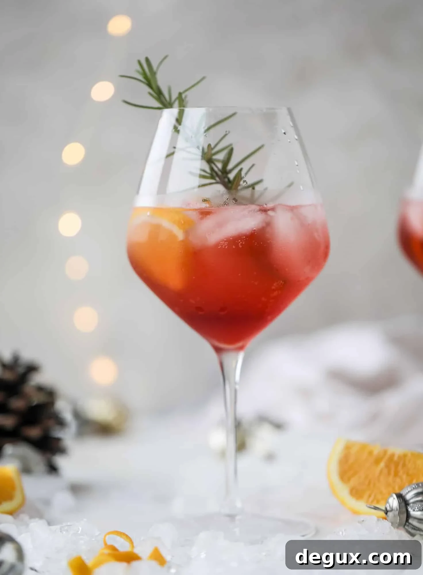 This winter aperol spritz cocktail is a seasonal spin on the classic aperol spritz! Festive cranberry and classic orange come together with prosecco and club soda to create a super light and refreshing cocktail for the holidays! I howsweeteats.com #aperol #spritz