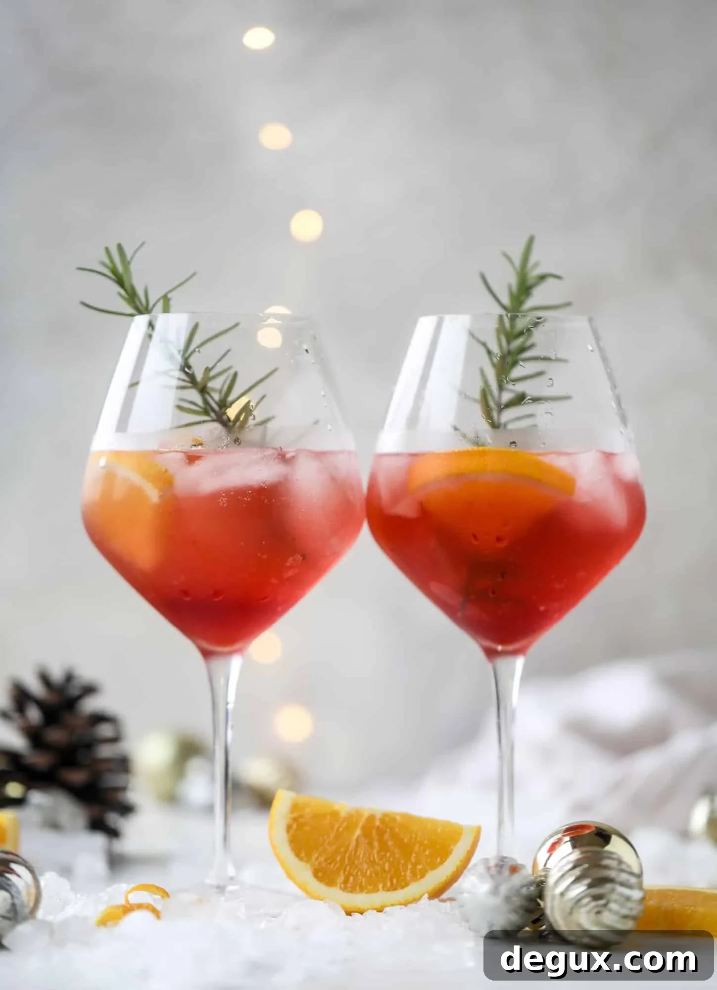 This winter aperol spritz cocktail is a seasonal spin on the classic aperol spritz! Festive cranberry and classic orange come together with prosecco and club soda to create a super light and refreshing cocktail for the holidays! I howsweeteats.com #aperol #spritz