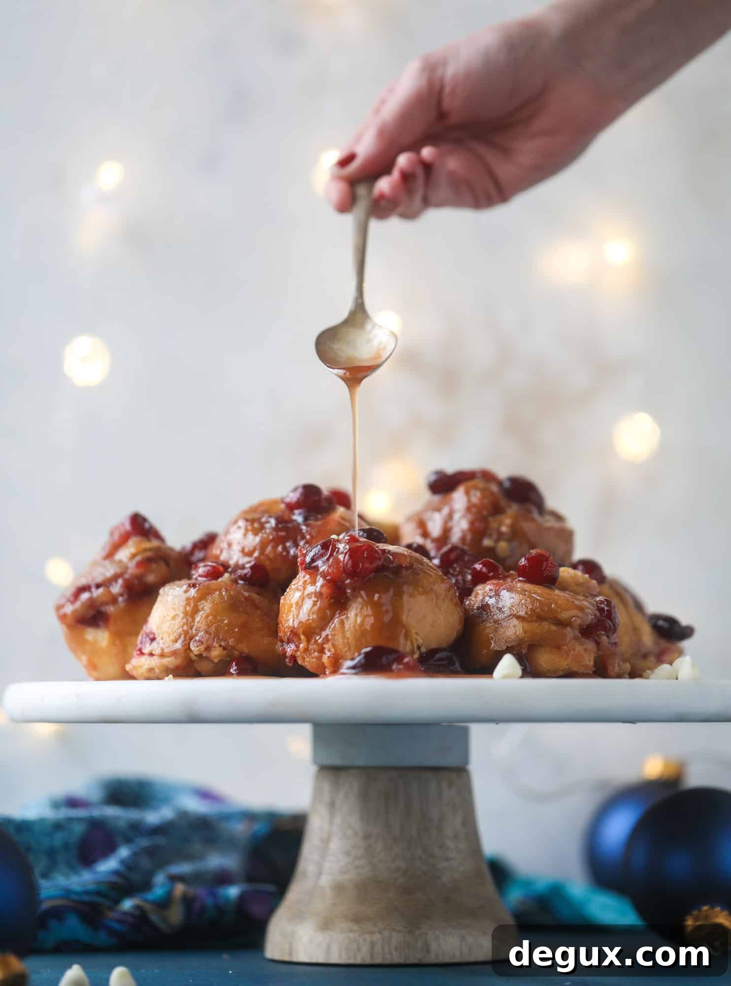These white chocolate cranberry sticky buns are what holiday dreams are made of! Made in a muffin tin with fresh cranberries and creamy white chocolate, they are drizzled with cranberry caramel too! Dreamy! I howsweeteats.com #sticky #buns