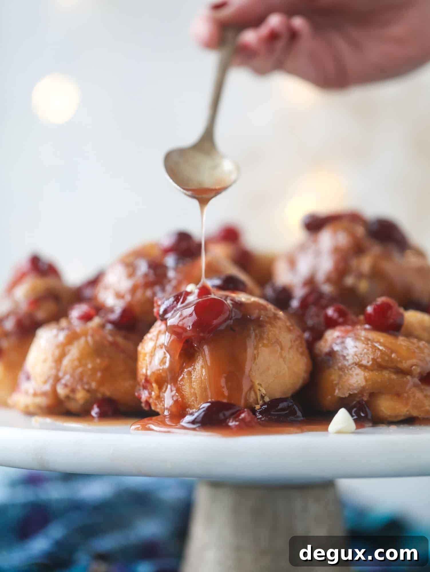 These white chocolate cranberry sticky buns are what holiday dreams are made of! Made in a muffin tin with fresh cranberries and creamy white chocolate, they are drizzled with cranberry caramel too! Dreamy! I howsweeteats.com #sticky #buns