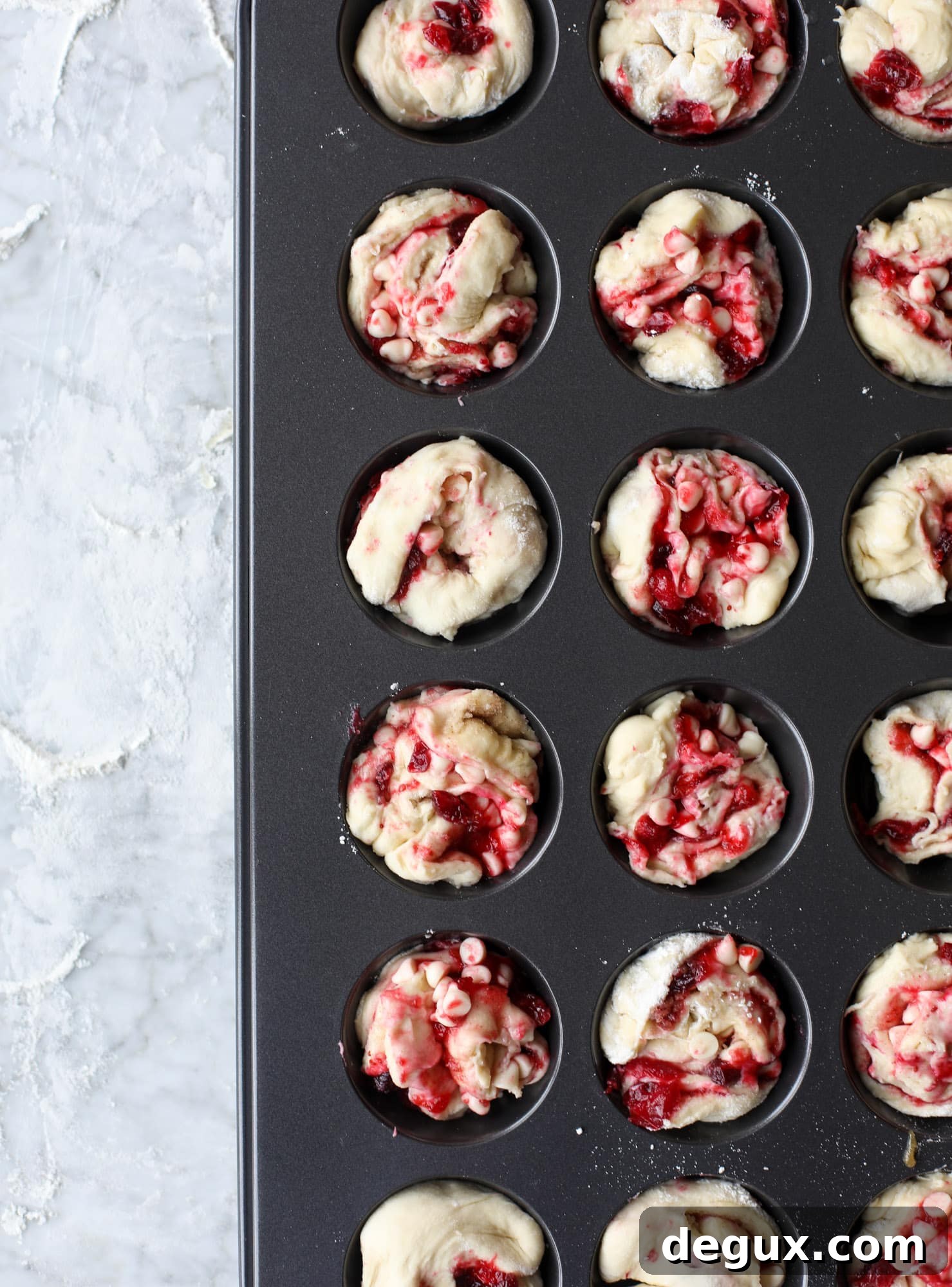 These white chocolate cranberry sticky buns are what holiday dreams are made of! Made in a muffin tin with fresh cranberries and creamy white chocolate, they are drizzled with cranberry caramel too! Dreamy! I howsweeteats.com #sticky #buns