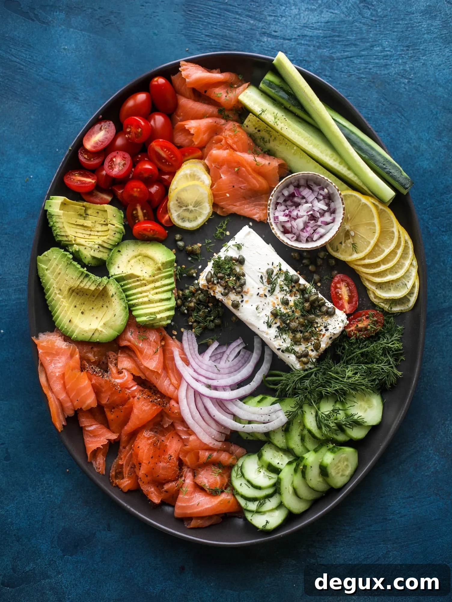 This is my favorite way to make an incredible smoked salmon platter! Fresh smoked salmon with bagels, soft boiled eggs, cream cheese and capers, everything seasoning and so much more. Perfect for holiday breakfasts and brunches! I howsweeteats.com #smokedsalmon #platter