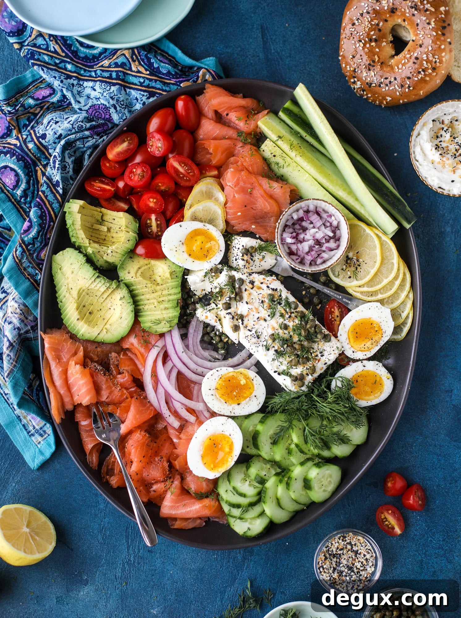 This is my favorite way to make an incredible smoked salmon platter! Fresh smoked salmon with bagels, soft boiled eggs, cream cheese and capers, everything seasoning and so much more. Perfect for holiday breakfasts and brunches! I howsweeteats.com #smokedsalmon #platter