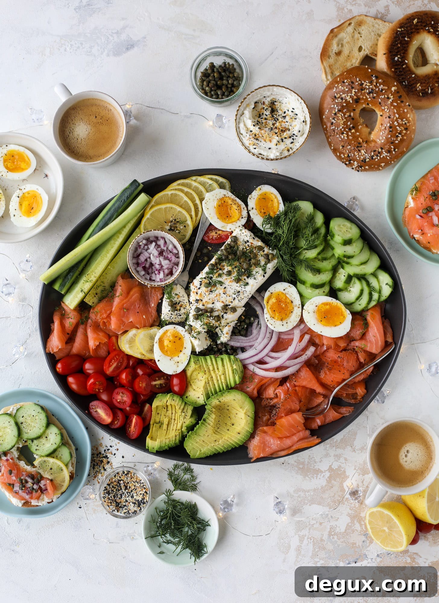 This is my favorite way to make an incredible smoked salmon platter! Fresh smoked salmon with bagels, soft boiled eggs, cream cheese and capers, everything seasoning and so much more. Perfect for holiday breakfasts and brunches! I howsweeteats.com #smokedsalmon #platter