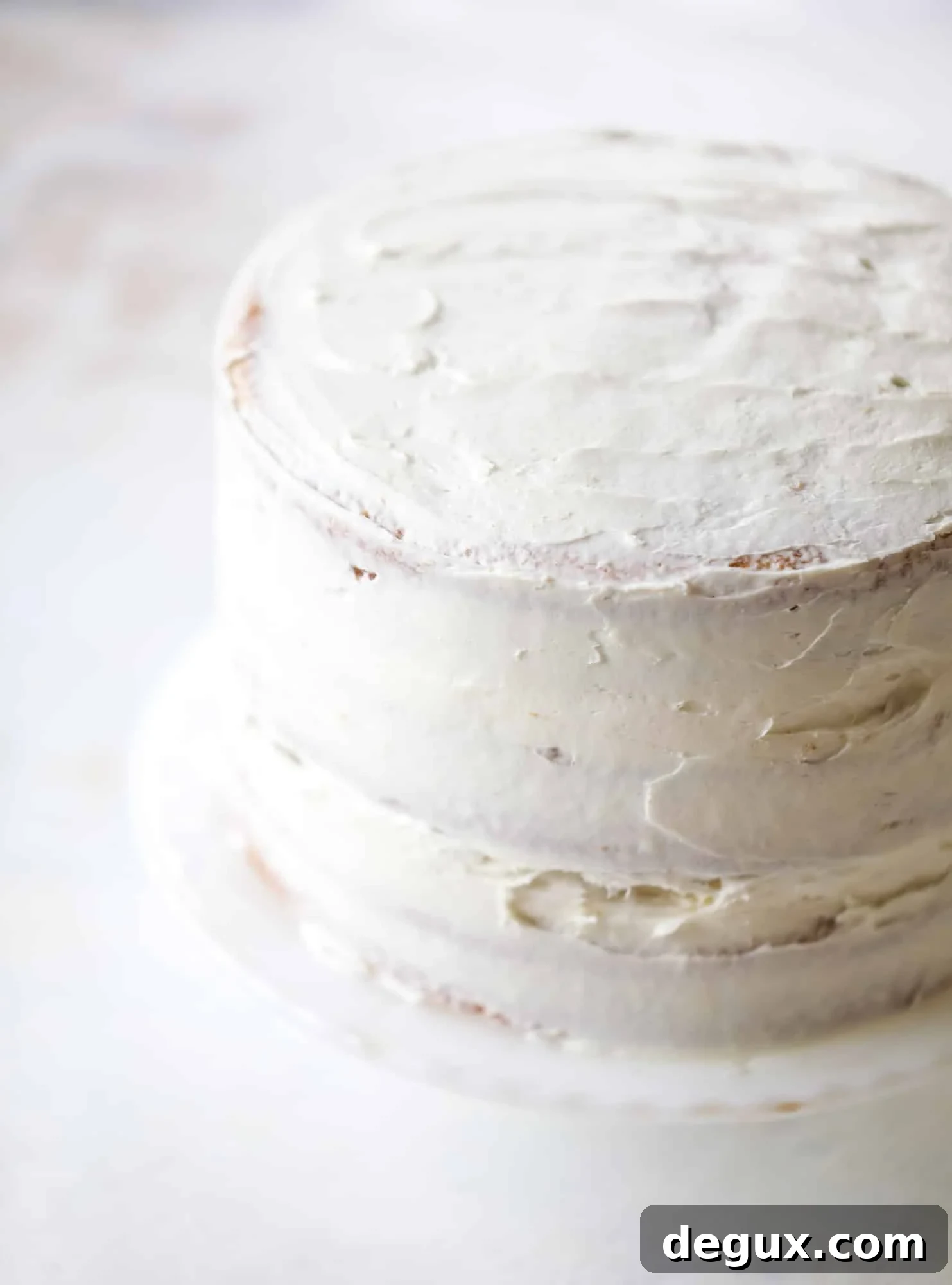 This pink peppermint cake is festive and delicious for the holidays! Layers of vanilla cake frosting with peppermint cream cheese frosting, covered in sparkly sugar and peppermint meringues. Couldn't be cuter! I #pinkpeppermint #cake