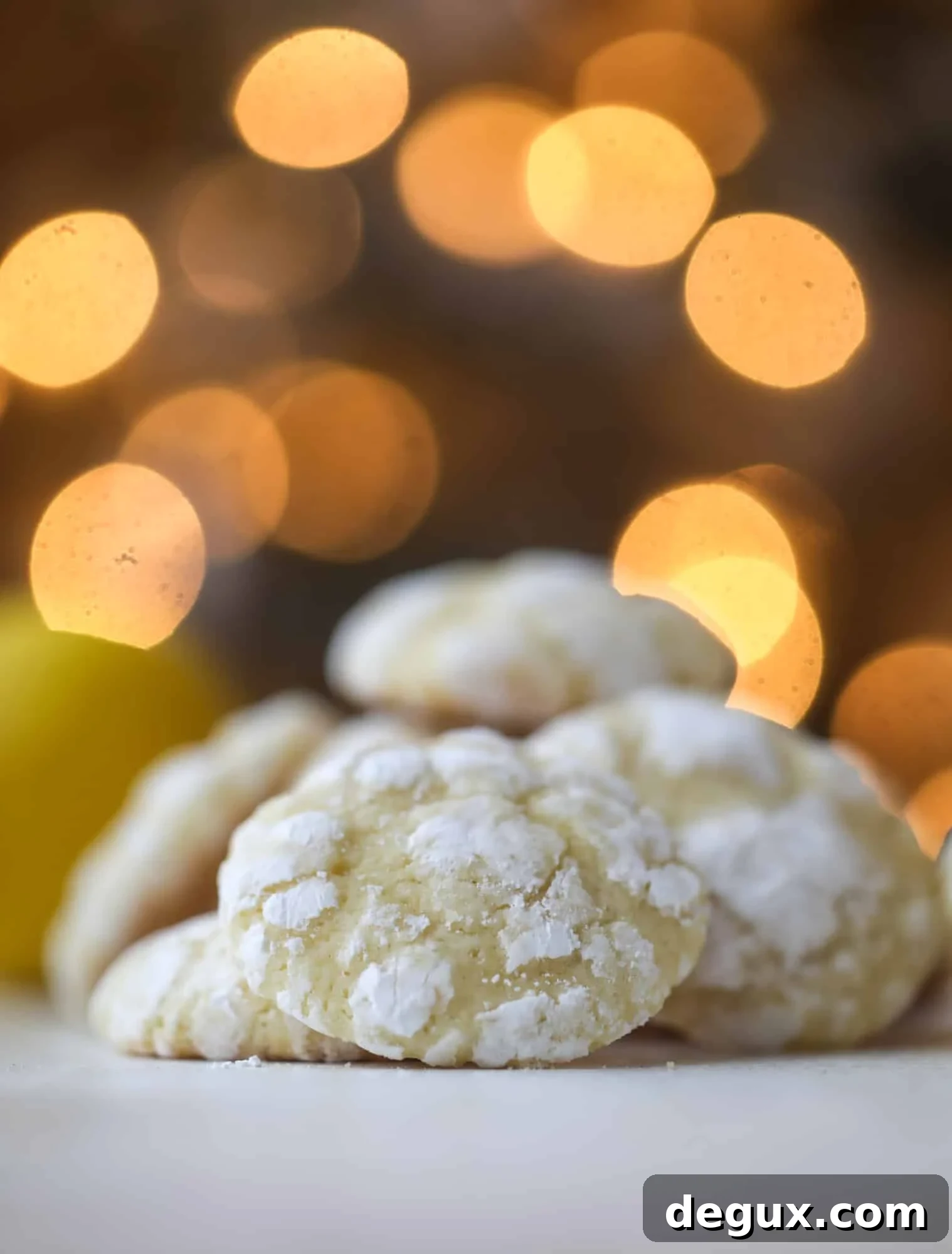 These lemon crinkle cookies are perfect if you love lemon desserts! They take after chocolate crinkle cookies, but are a delightful refreshing lemon flavor sprinkle with powdered sugar. These are always a huge hit! I howsweeteats.com #lemoncrinkle #cookies