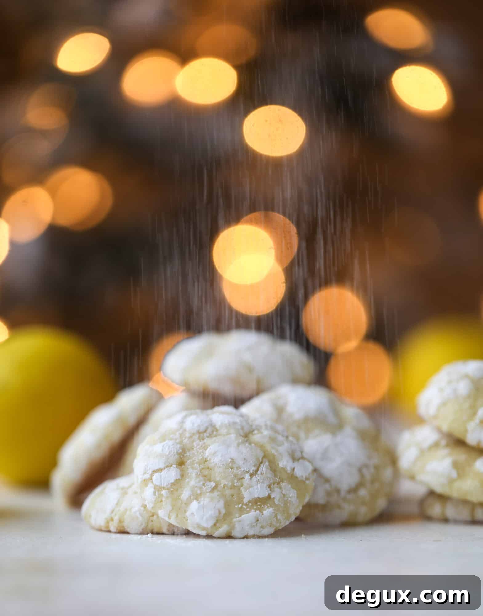 Baked lemon crinkle cookies cooling on a rack.