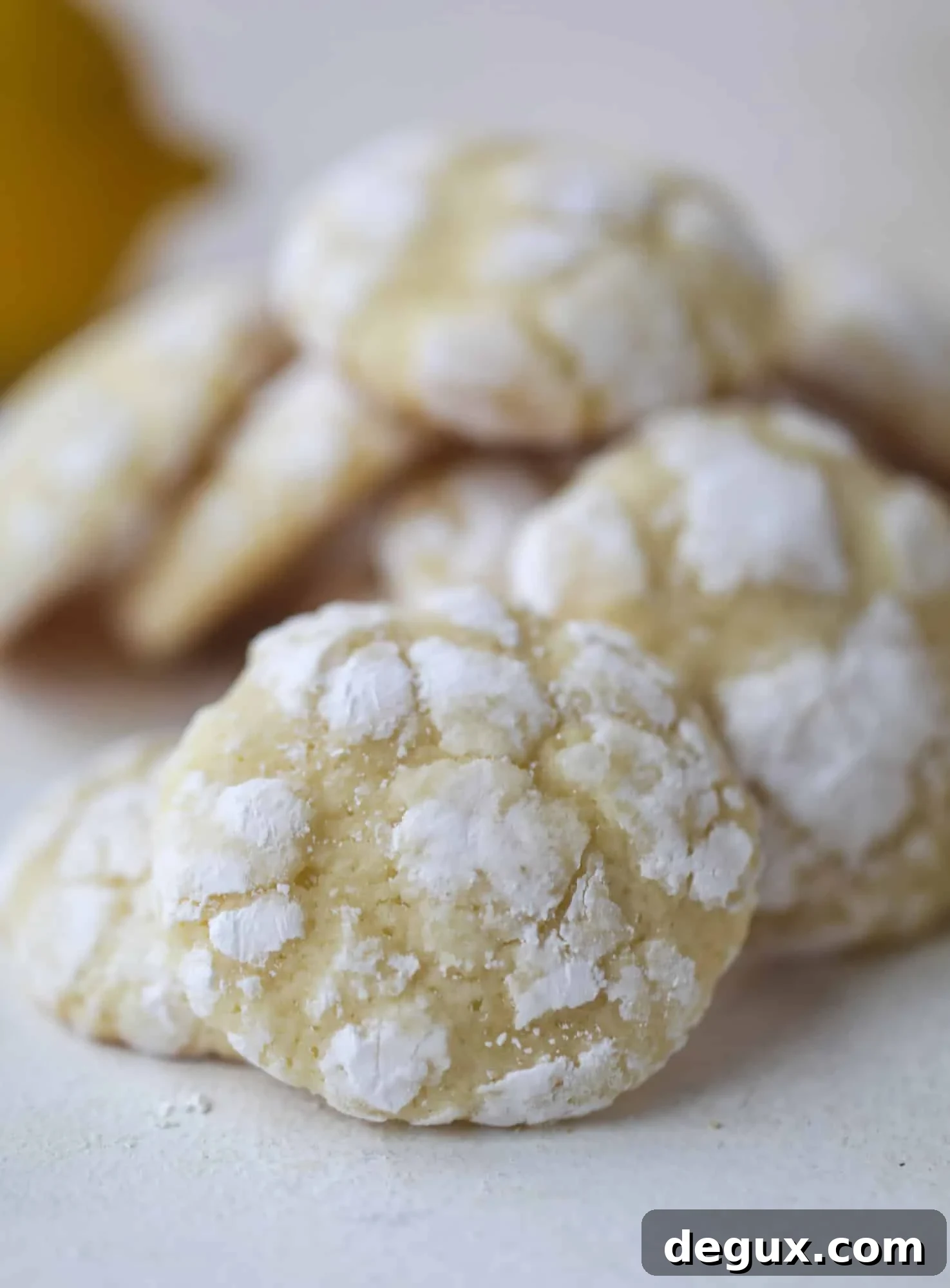 These lemon crinkle cookies are perfect if you love lemon desserts! They take after chocolate crinkle cookies, but are a delightful refreshing lemon flavor sprinkle with powdered sugar. These are always a huge hit! I howsweeteats.com #lemoncrinkle #cookies