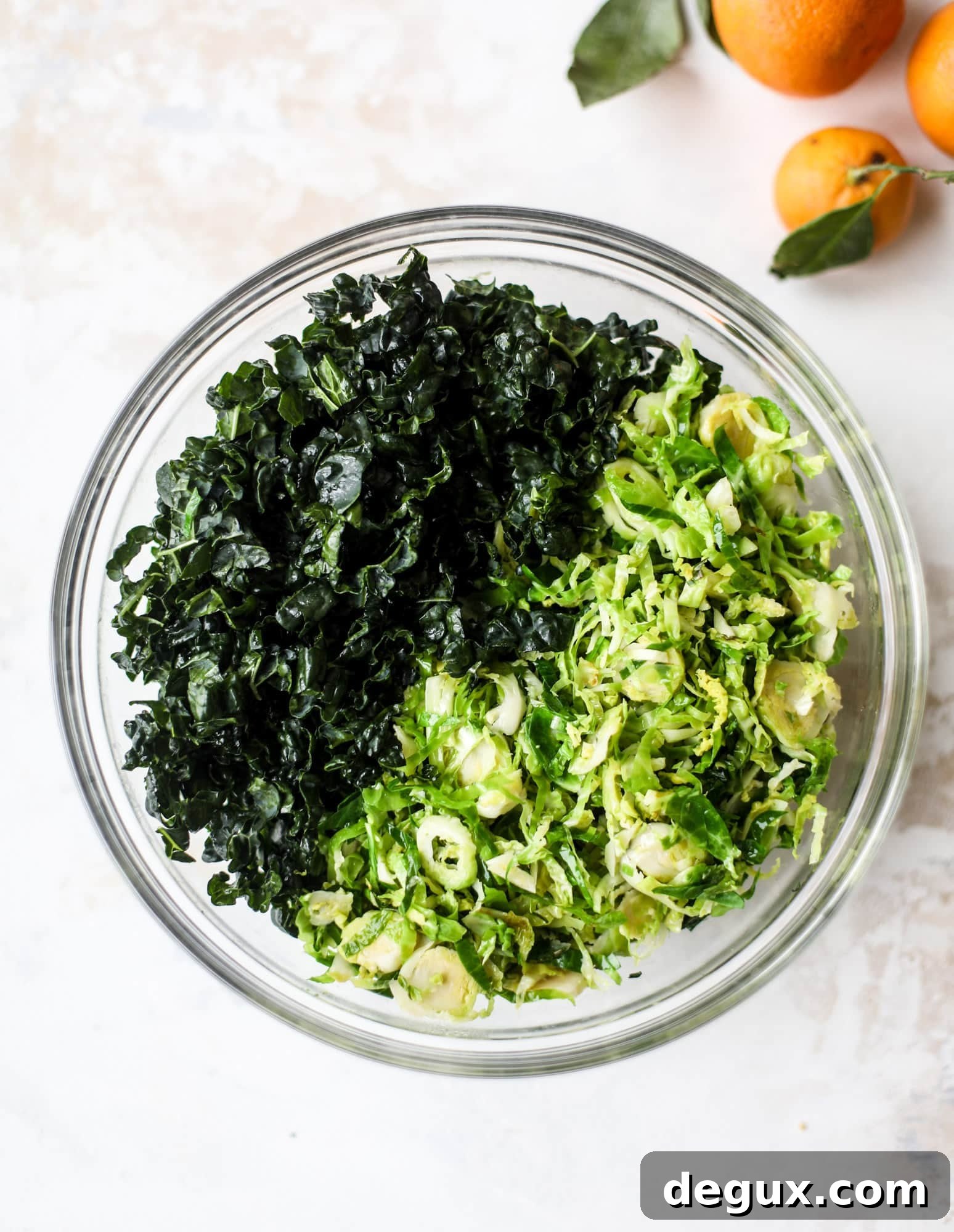This winter crunch salad is loaded with tons of delicious, crunchy seasonal ingredients. A base of brussels sprouts and kale is topped with sliced apples, satsuma wedges, pomegranate arils, toasted walnuts and savory flaked coconut crunch. Delish! I howsweeteats.com #winter #salad
