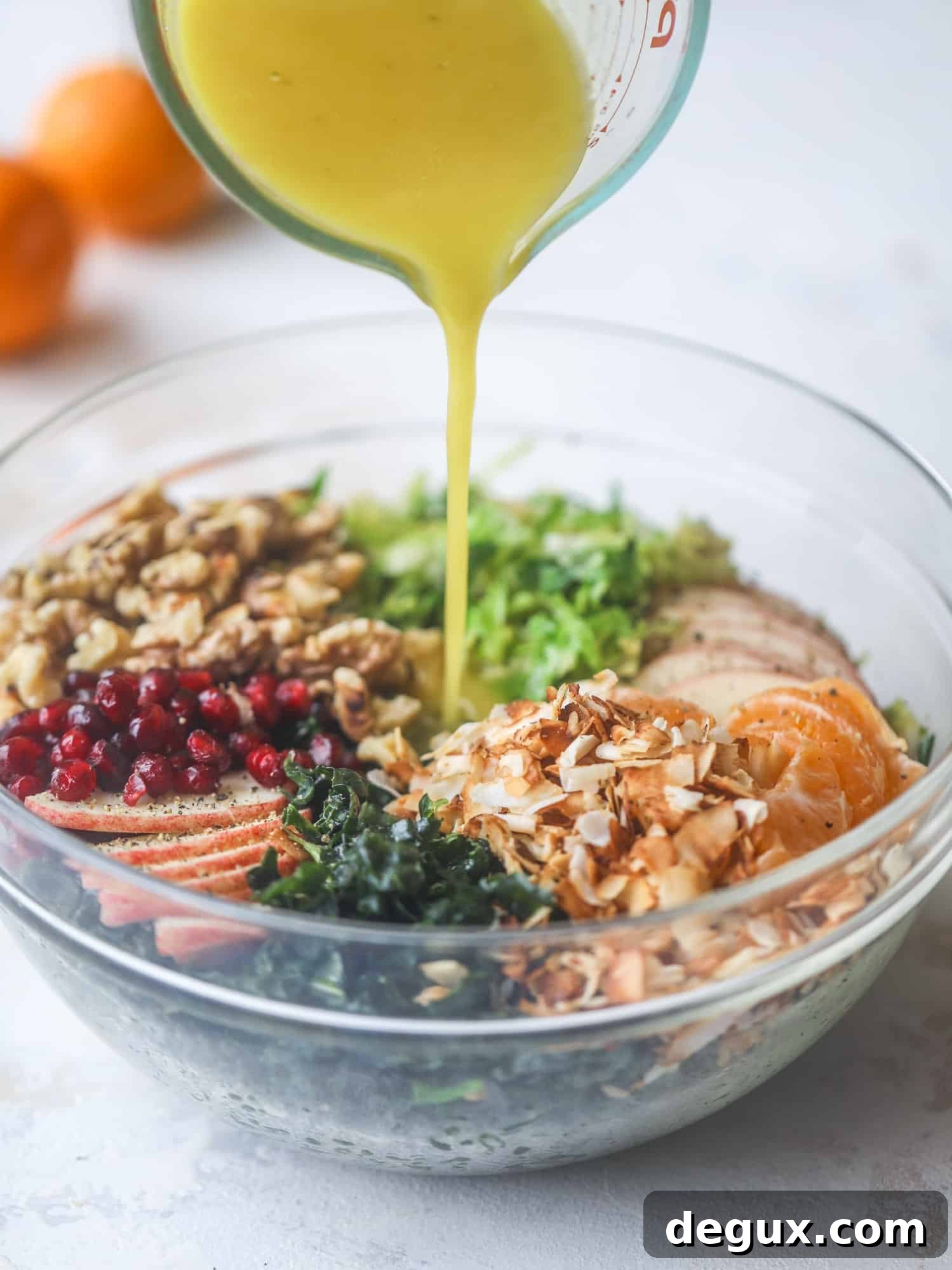 This winter crunch salad is loaded with tons of delicious, crunchy seasonal ingredients. A base of brussels sprouts and kale is topped with sliced apples, satsuma wedges, pomegranate arils, toasted walnuts and savory flaked coconut crunch. Delish! I howsweeteats.com #winter #salad