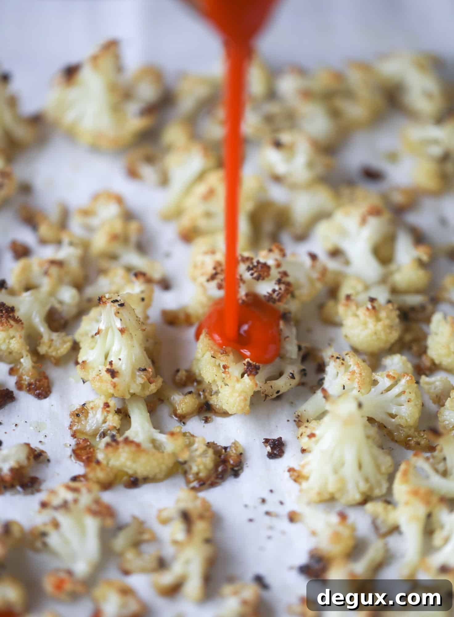 These buffalo cauliflower lettuce wraps are perfect for game day or even a quick weeknight dinner. Roasted cauliflower with buffalo wing sauce, sliced avocado, crumbled blue cheese, scallions, cilantro and chives makes for a flavor explosion! I howsweeteats.com #buffalo #cauliflower