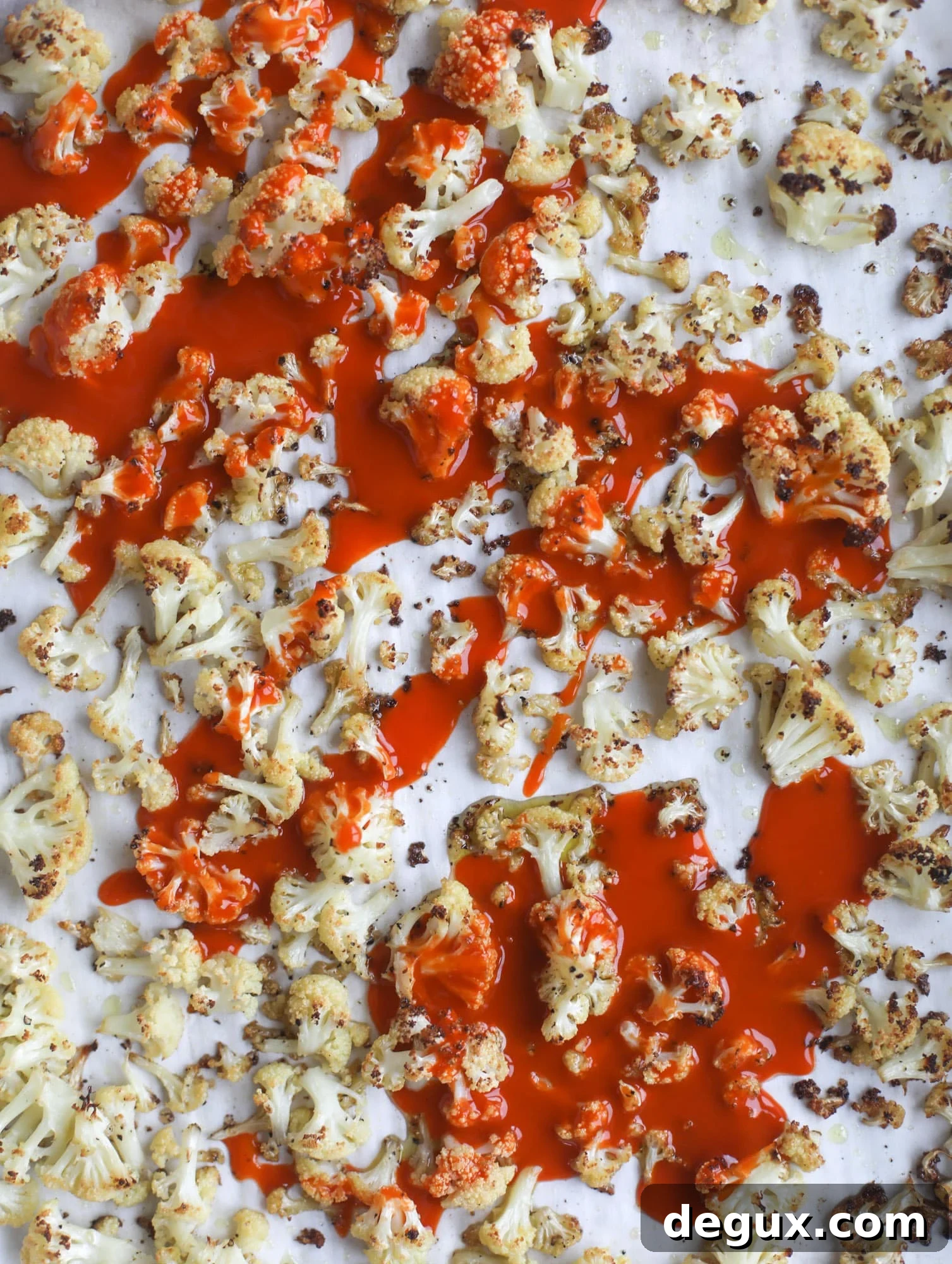 These buffalo cauliflower lettuce wraps are perfect for game day or even a quick weeknight dinner. Roasted cauliflower with buffalo wing sauce, sliced avocado, crumbled blue cheese, scallions, cilantro and chives makes for a flavor explosion! I howsweeteats.com #buffalo #cauliflower