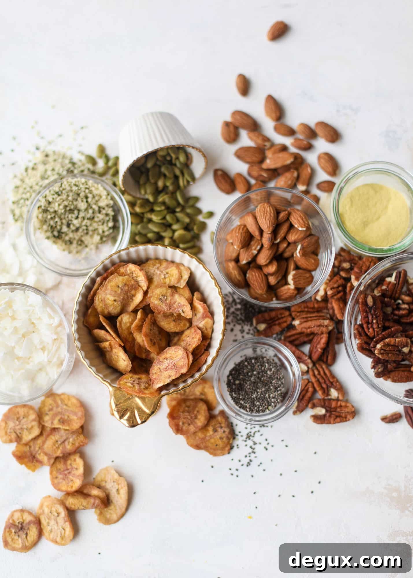 This delicious healthy snack mix is perfect to prep for snacks on the go! It's satisfying, flavorful, both sweet and savory and the best part - is super crunchy. It's full of nuts, some fruit, a bit of coconut, spices, hemp hearts and chia! I howsweeteats.com #healthy #trailmix
